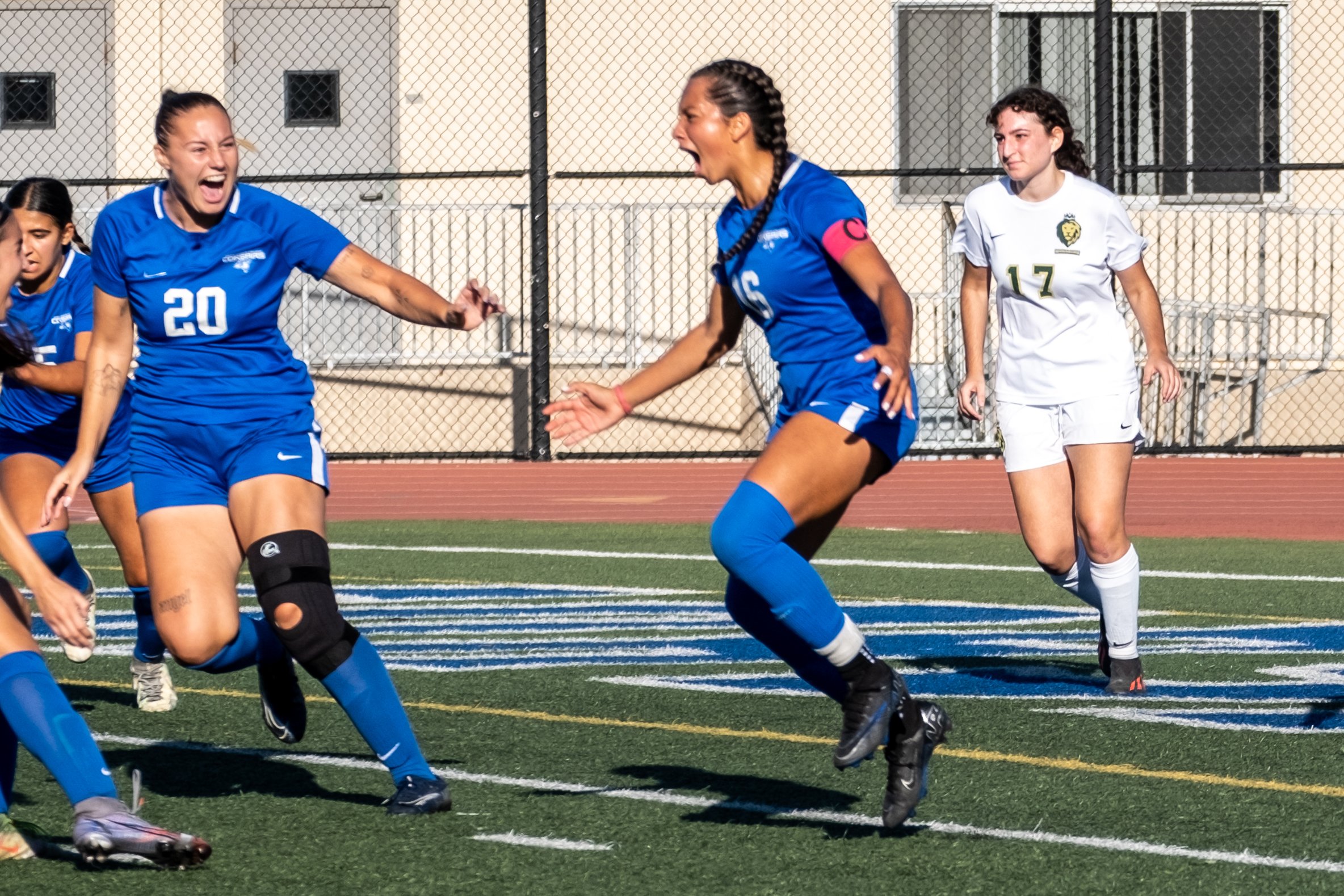  Santa Monica Corsairs' Alicia Edberg (left) and Bella Velazco (center) celebrate the first goal of the game, scored by Velazco. LA Valley College Monarch Jacky Hernandez (left) looks on, during the women's soccer match on Friday, Oct. 6, 2023 at Cor