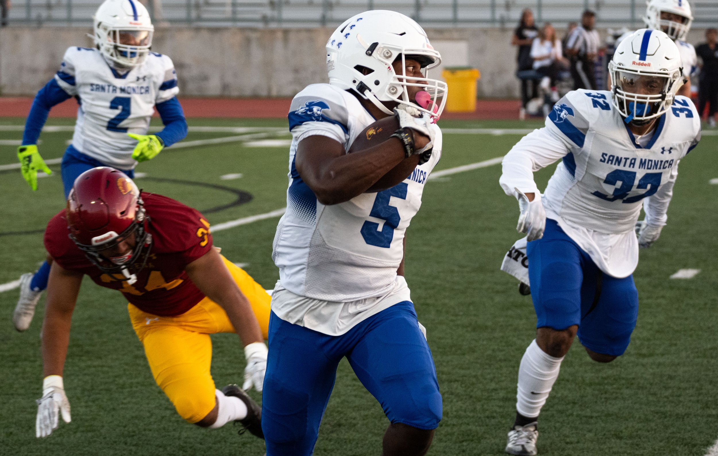  Santa Monica College Corsair wide reciever Myles Parker(5) getting passed Pasadena City College(PCC) Lancer running back Micah Mendoza(34) at the start of the game at Robinson Stadium in PCC campus on Saturday, Oct. 14 Walnut, Calif. (Danilo Perez |