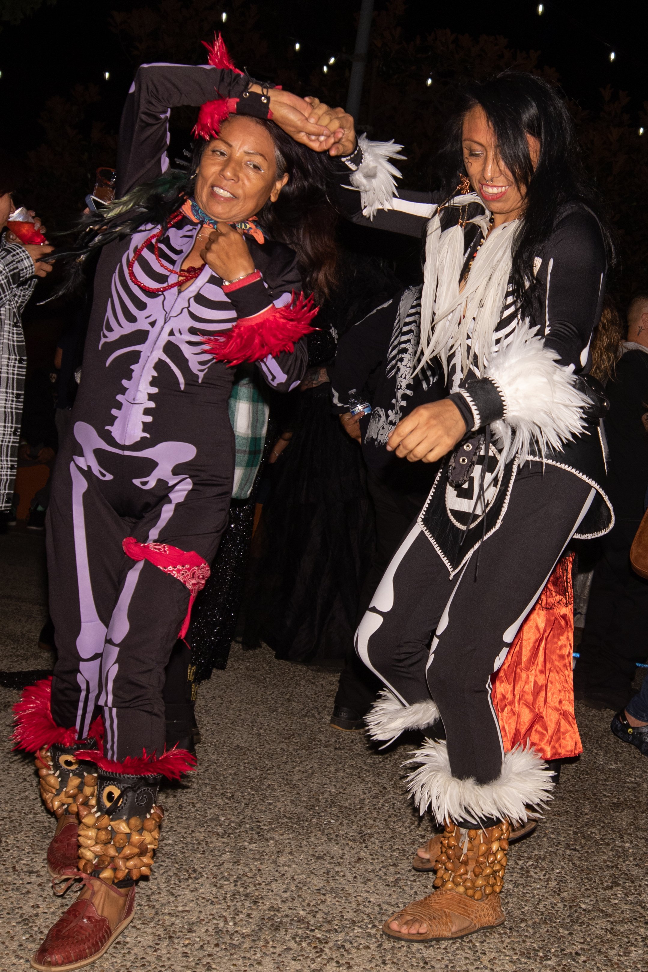  A couple of Aztec dancers salsa dancing to the DJ between sets of live music at El Velorio's 13th Day of the Dead Music & Arts Festival at La Plaza de la Raza, Los Angeles, Calif. on Saturday Oct. 14, 2023. (Akemi Rico | The Corsair) 