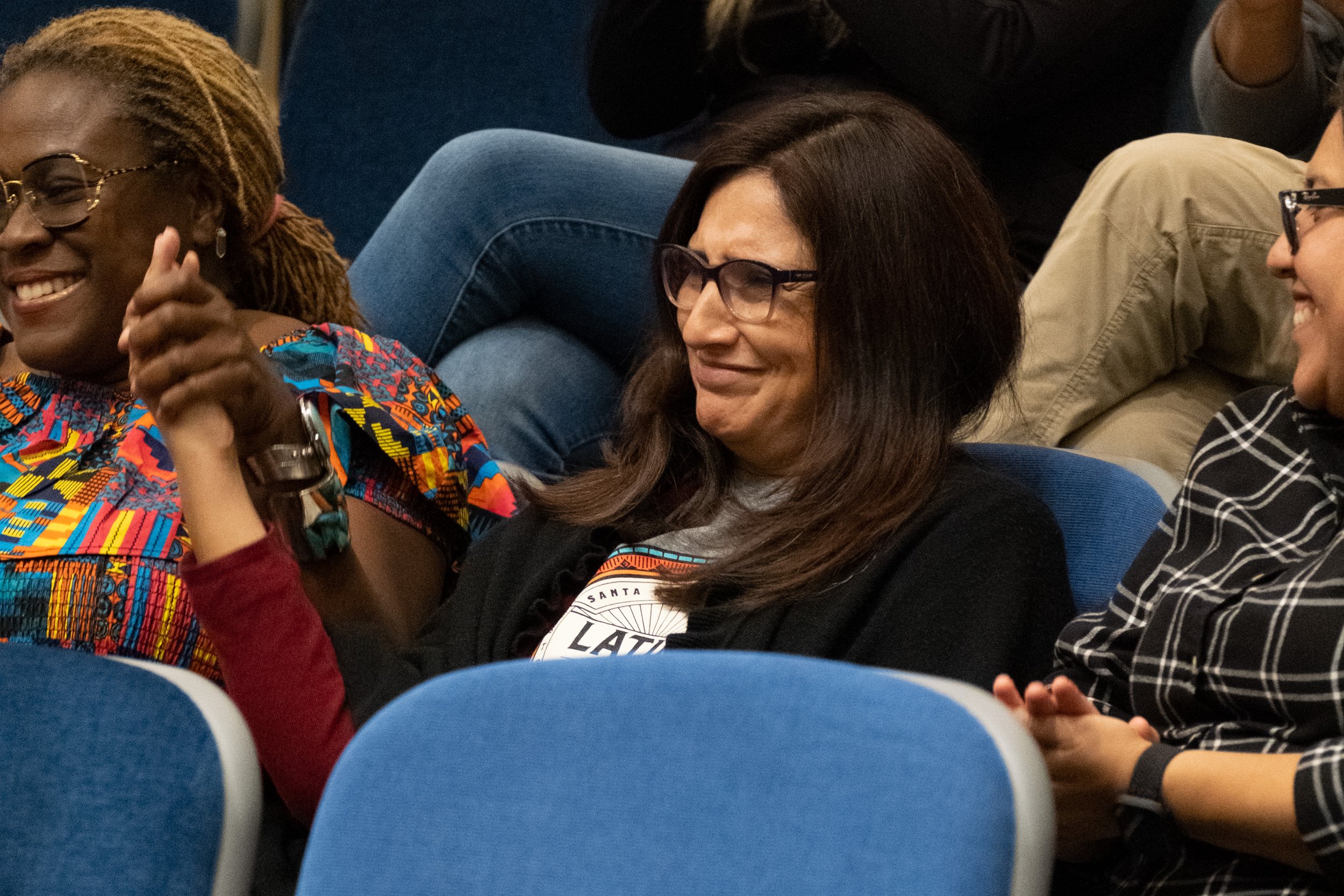  Marisol Moreno, faculty lead for the DREAM resource center, smiles as she is recognized and applauded at the community gathering in lieu of a protest against the play "By The River Rivanna" in the Student Services Orientation Hall on the main campus
