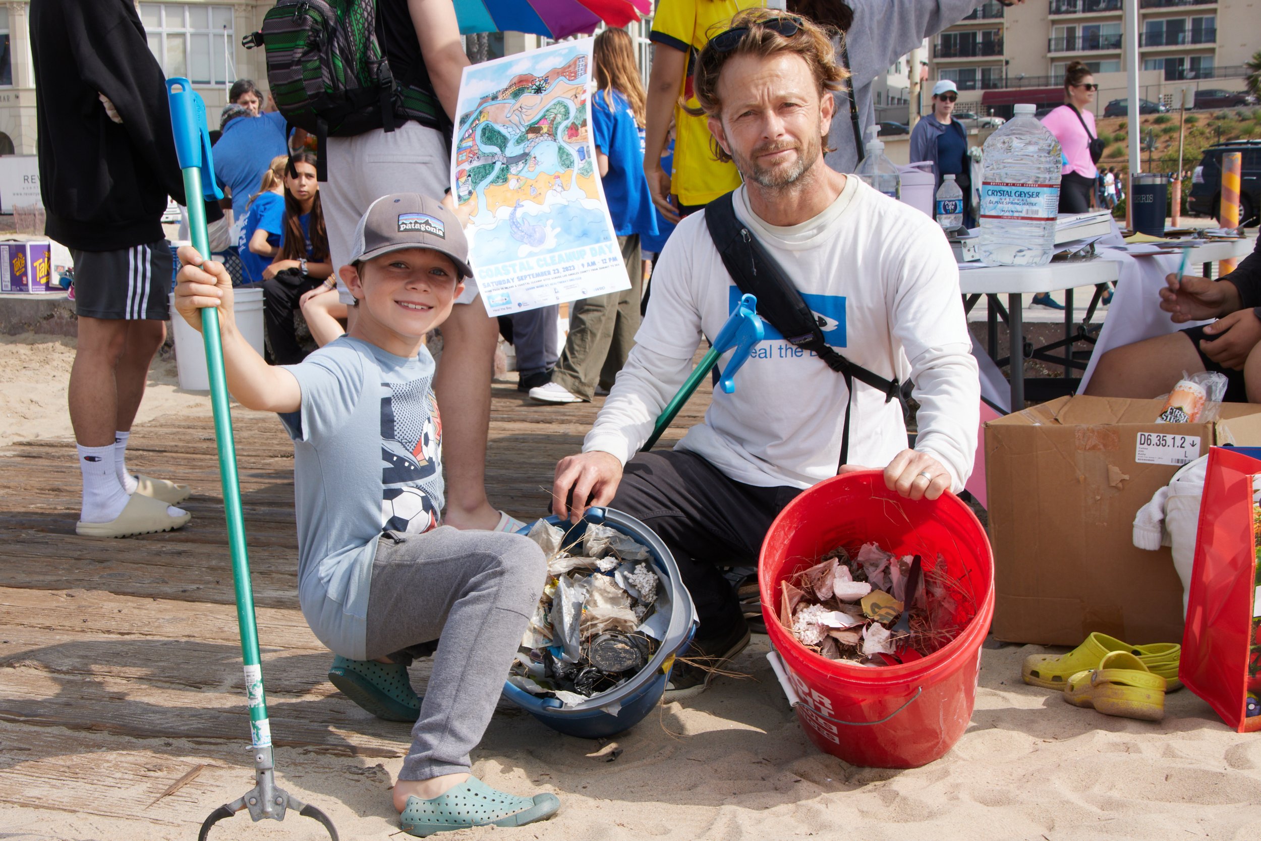  Marine biologist and professor at Santa Monica College (SMC) Benjamin Kay and his son Kody poses with two buckets of collected trash during a coastal beach cleanup organized by SMC Sustainability Center at The Inkwell, Santa Monica, Calif., on Sept.