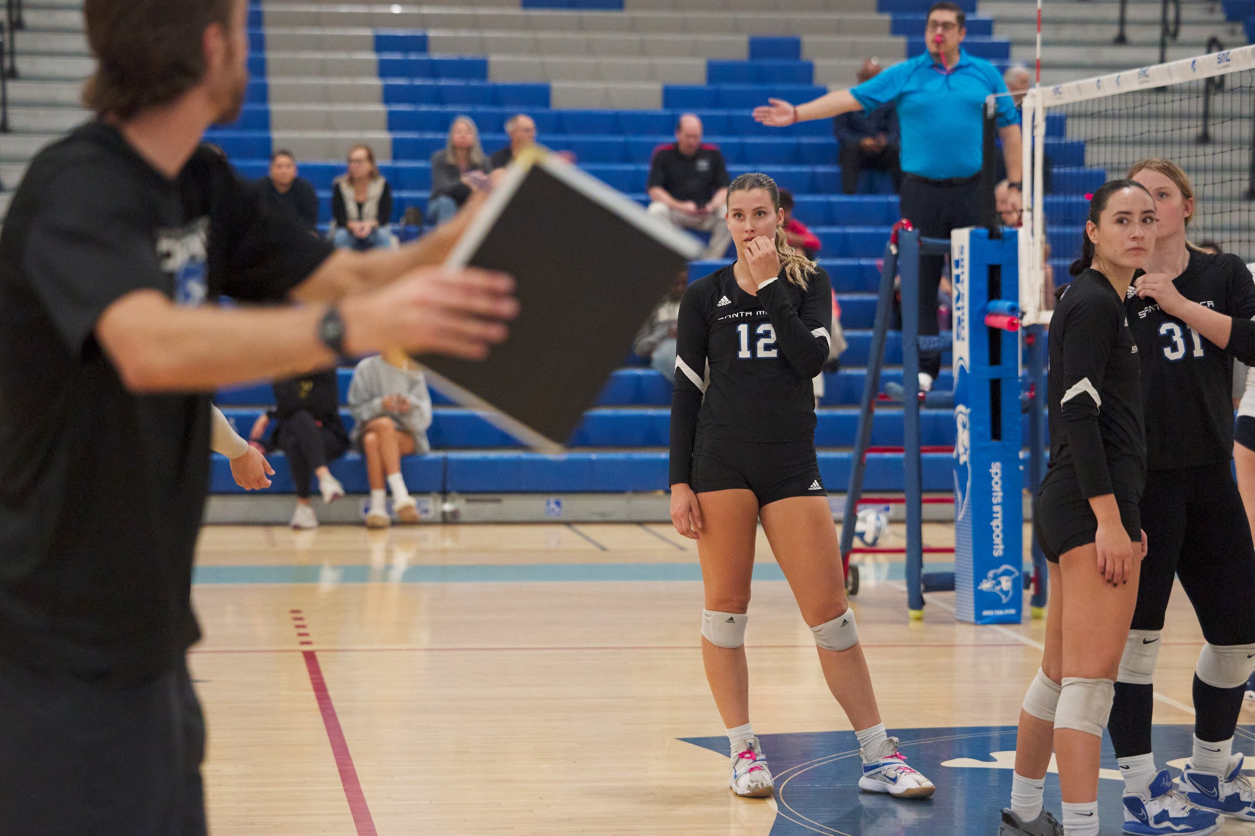  Santa Monica College Corsairs' Mia Paulson, Natalie Fernandez, and Mylah Niksa listen to assistant coach Chris Chown (far left) during the women's volleyball match against the Citrus College Owls on Wednesday, Oct. 25, 2026, at Corsair Gym in Santa 