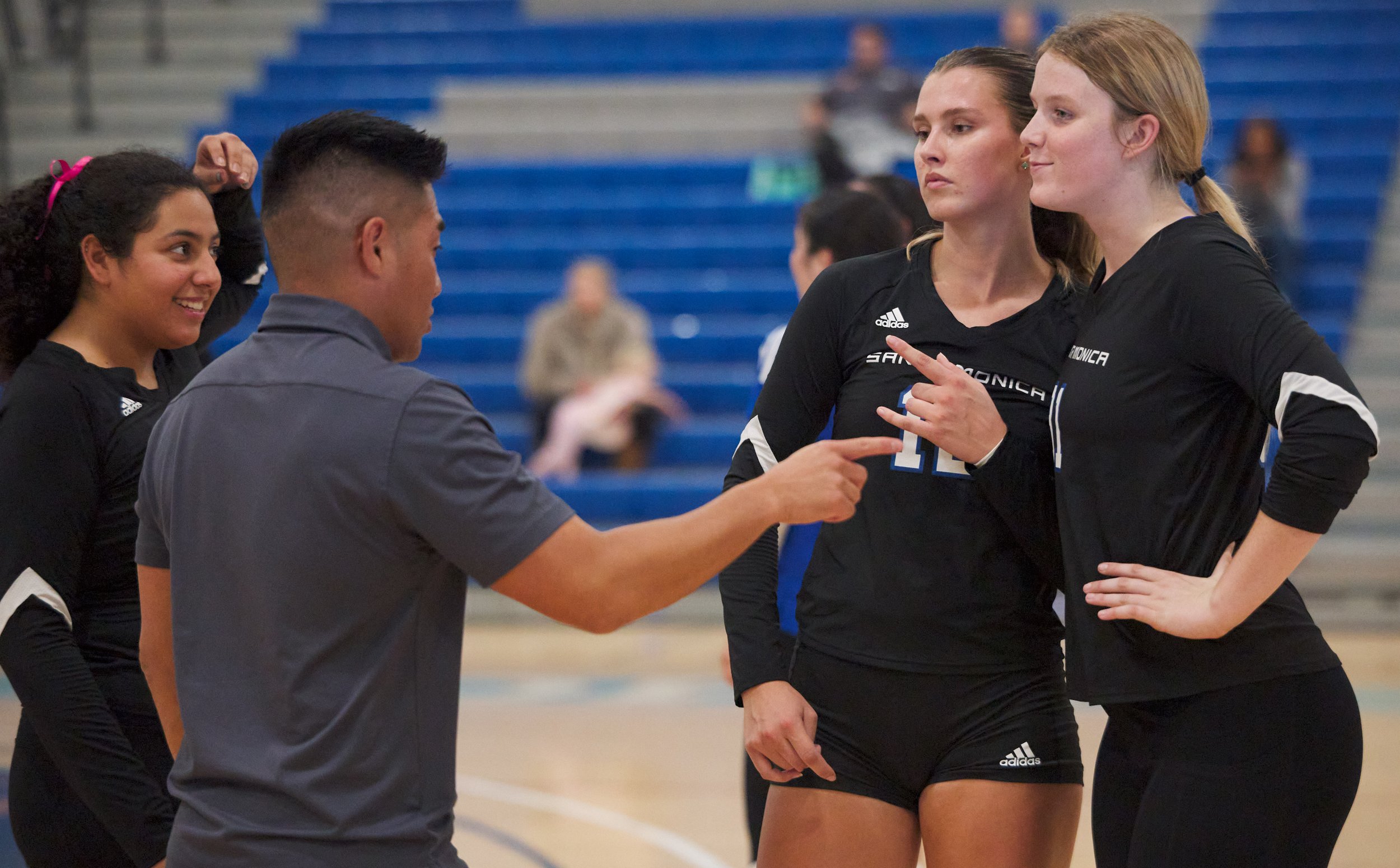  Santa Monica College Corsairs Women's Volleyball Head Coach Christian Cammayo (center left) talks to Jaylynn Fierro (left), Mia Paulson (center right), and Mylah Niksa (right)  during the match against the Citrus College Owls on Wednesday, Oct. 25, 