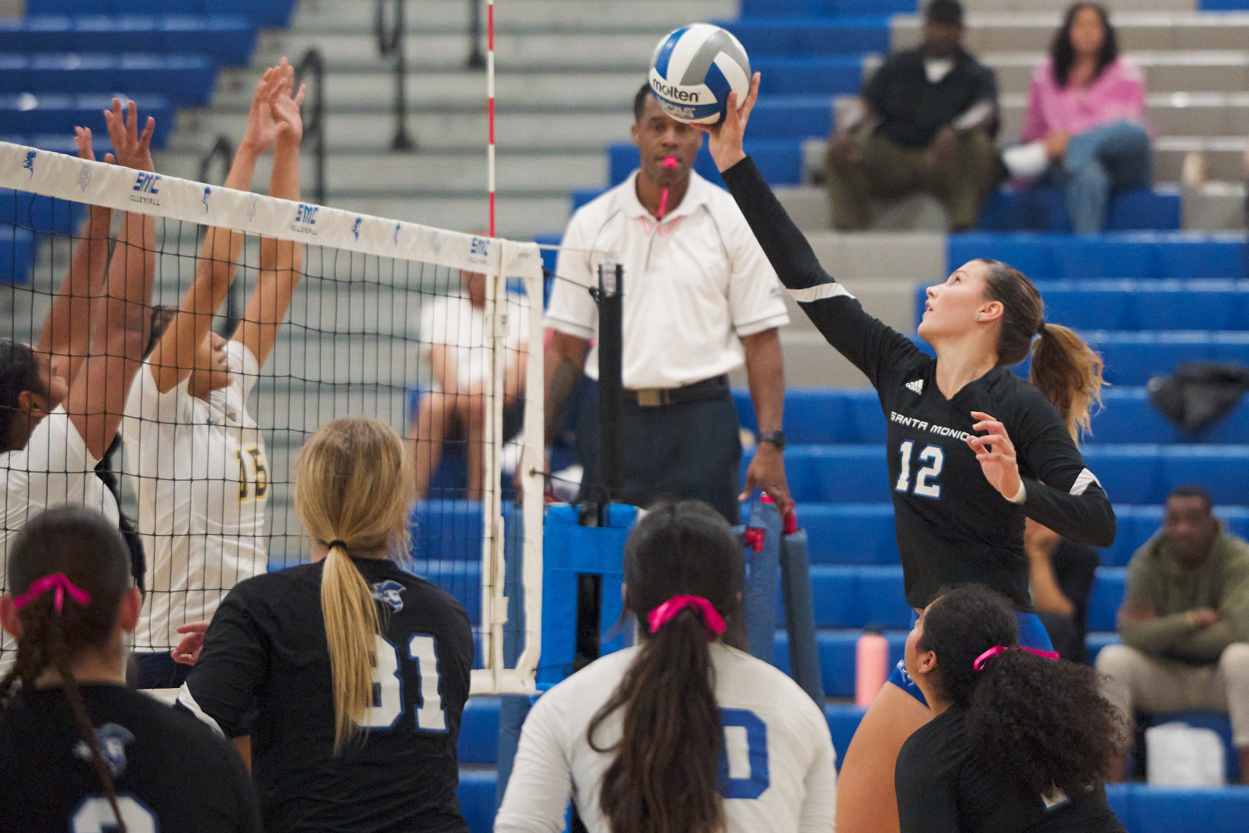  Santa Monica College Corsairs' Mia Paulson (right) hits the ball past College of the Canyons Cougars' (from left) Leah Gillie and Kaireese Johnson during the women's volleyball match on Friday, Oct. 27, 2023, at Corsair Gym in Santa Monica, Calif. T