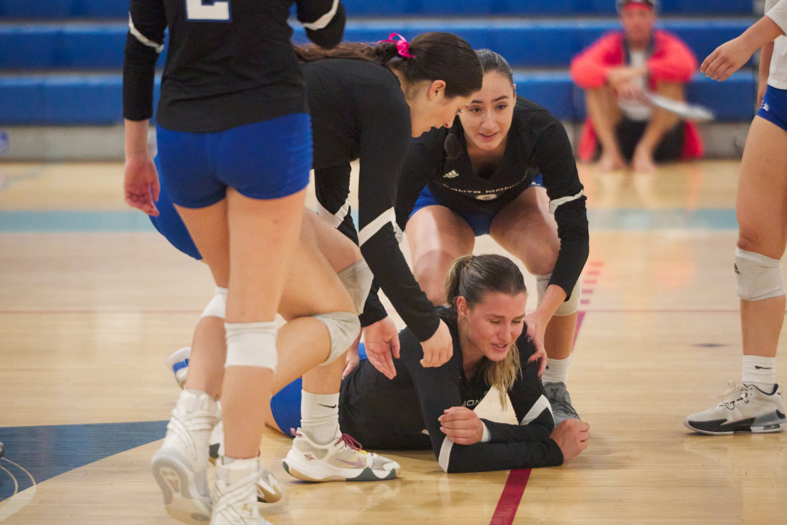  "She got me!" Mia Paulson lies on the floor, being assisted by Maiella Riva and Natalie Fernandez, after getting smacked in the face with the ball during the women's volleyball match against the College of the Canyons Cougars on Friday, Oct. 27, 202