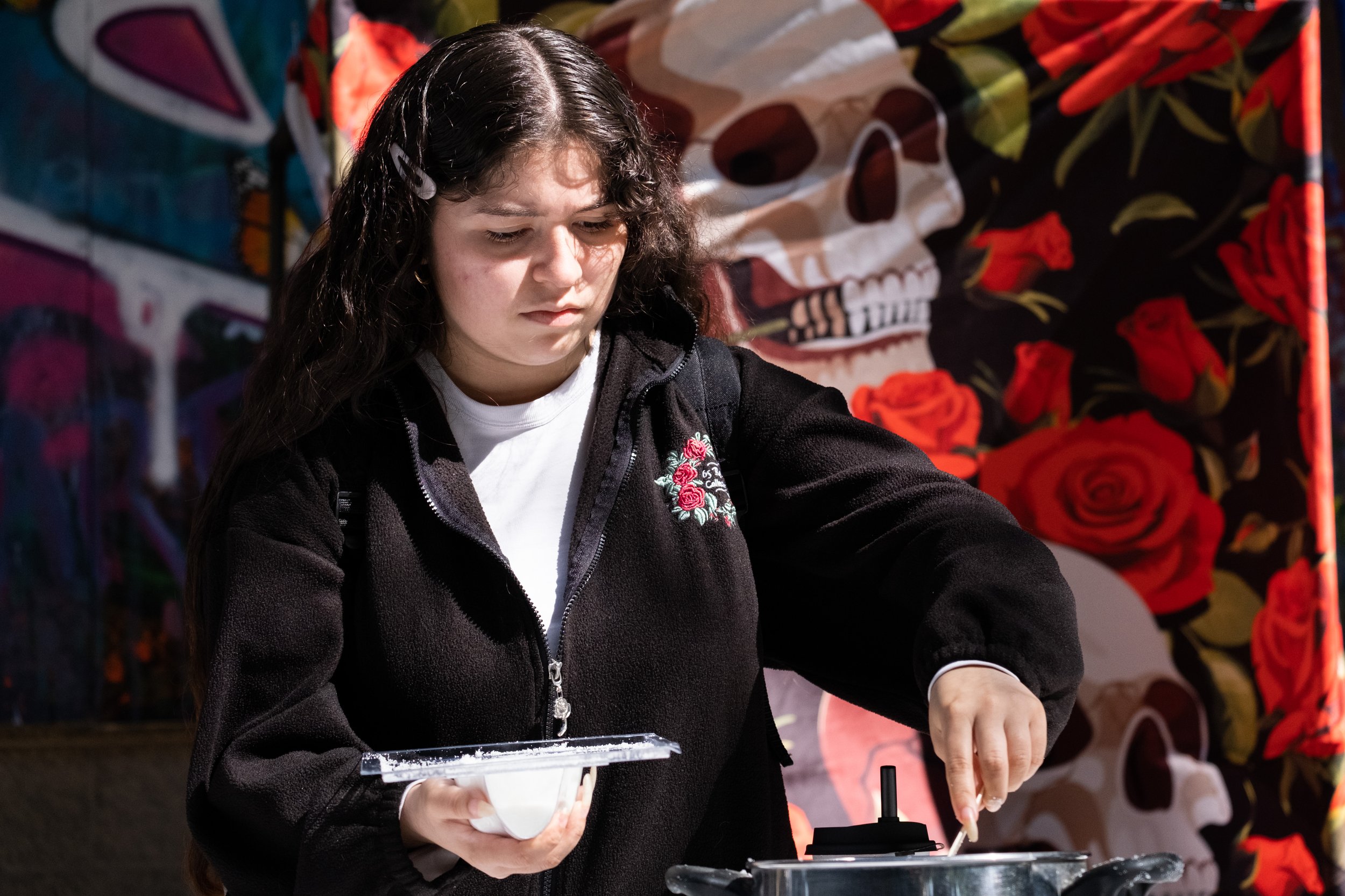  Santa Monica College (SMC) student, Magdalena Renderos smoothing sugar into a mold for making sugar skulls in the Art Department Patio at SMC's Main Campus in Santa Monica, Calif. on Thursday, Oct. 26, 2023. (Akemi Rico | The Corsair) 