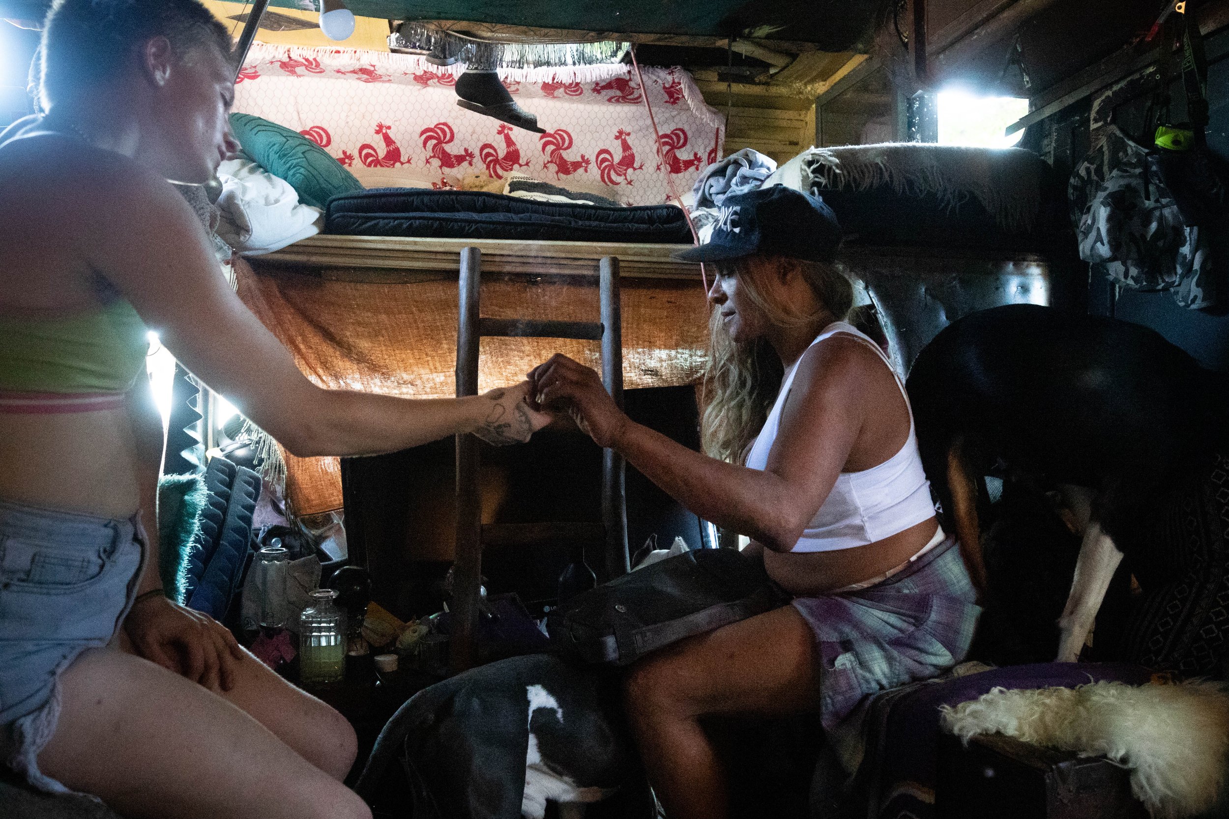  Rebecca Dannenbaum and her friend sharing a cigarette in the RV that she lives in on Venice Blvd. in Los Angeles, Calif., on Sept. 24, 2023. Dannenbaum has lived in this same spot for about seven years, and it has become a sort of hub for many of he