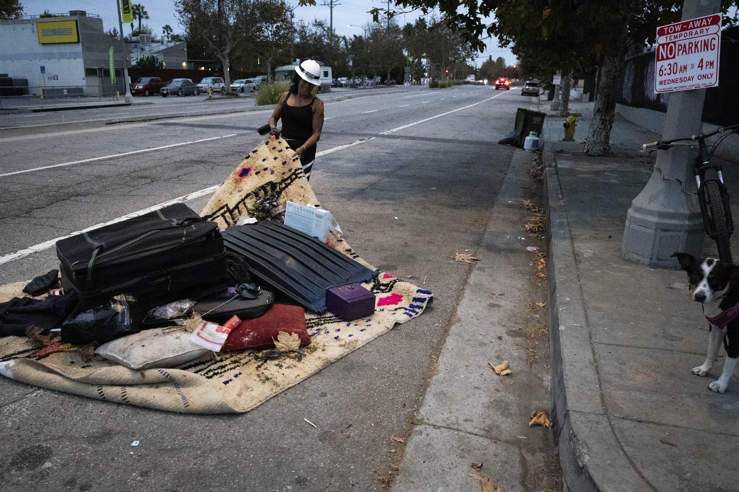  Rebecca Dannenbaum dragging a pile of trash away from the RV she lives in on Venice Blvd. in Los Angeles, Calif., on Monday, Oct. 23, 2023. She says that she piles trash up to make it easier for sanitation teams to take, but they never do. So, she m