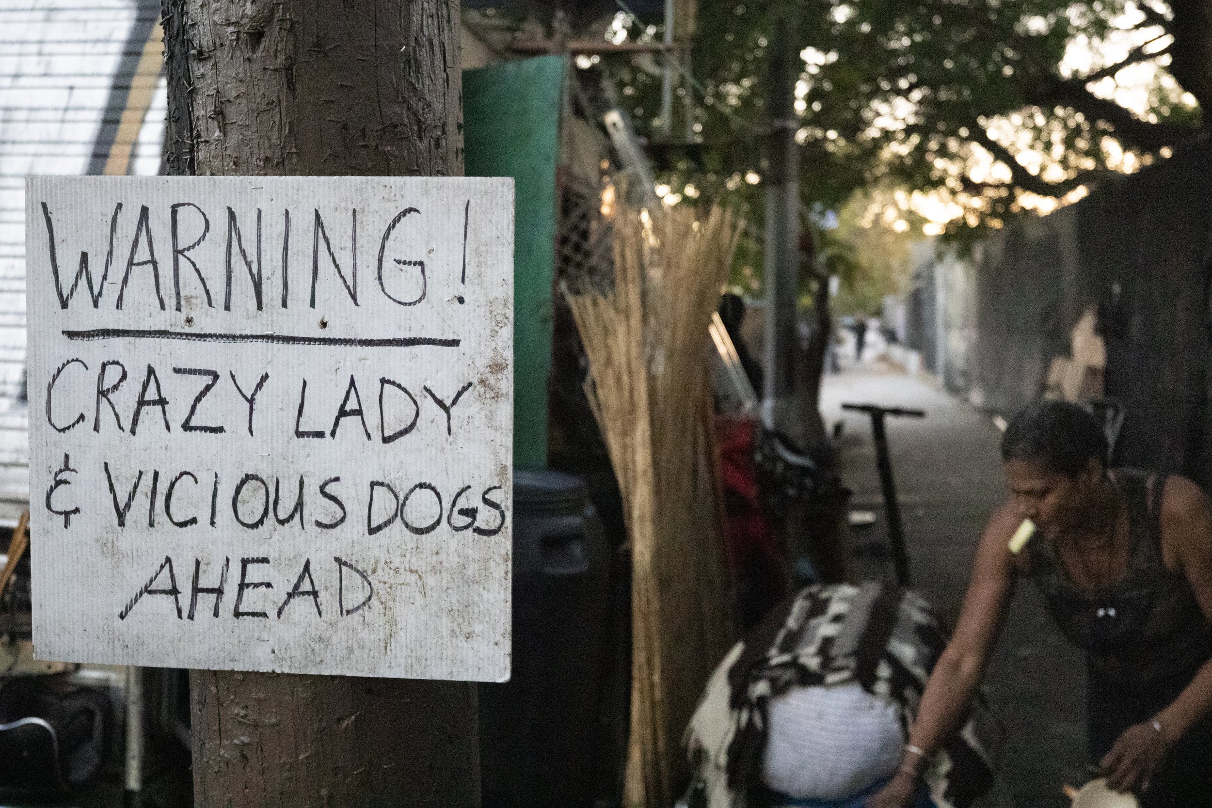  A sign which reads, “WARNING, CRAZY LADY & VICIOUS DOGS AHEAD,” stapled on a pole near the RV that Rebecca Dannenbaum lives in on Venice Blvd., in Los Angeles, Calif., on Nov. 5, 2023. Dannenbaum says it was put up soon after a neighbor’s dog attack