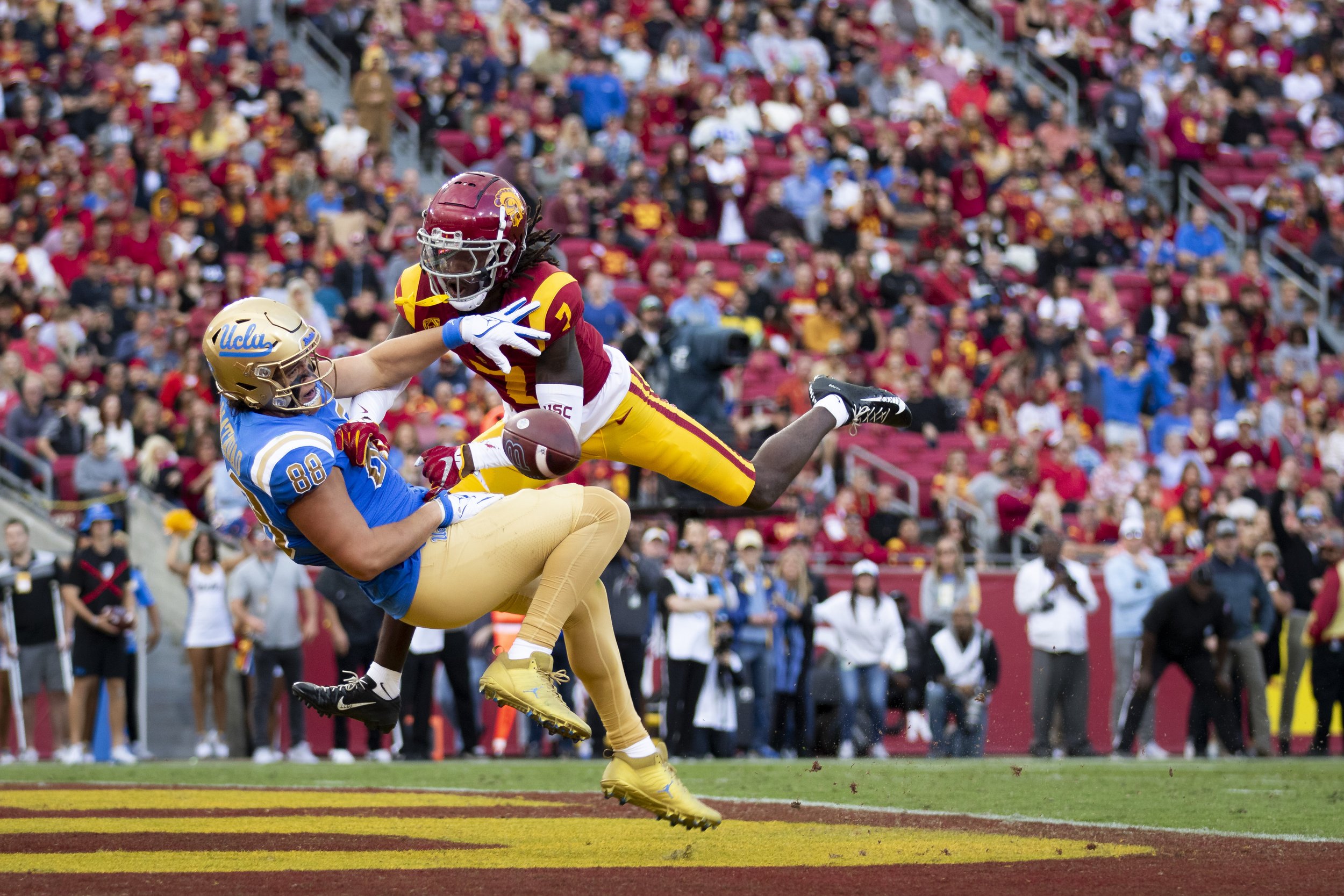 University of California, Los Angeles (UCLA) Bruin tight end Moliki Matavao (left) being tackled in the end zone by University of Southern California (USC) Trojan safety Calen Bullock (right) during the first quarter of a football game at the Los An