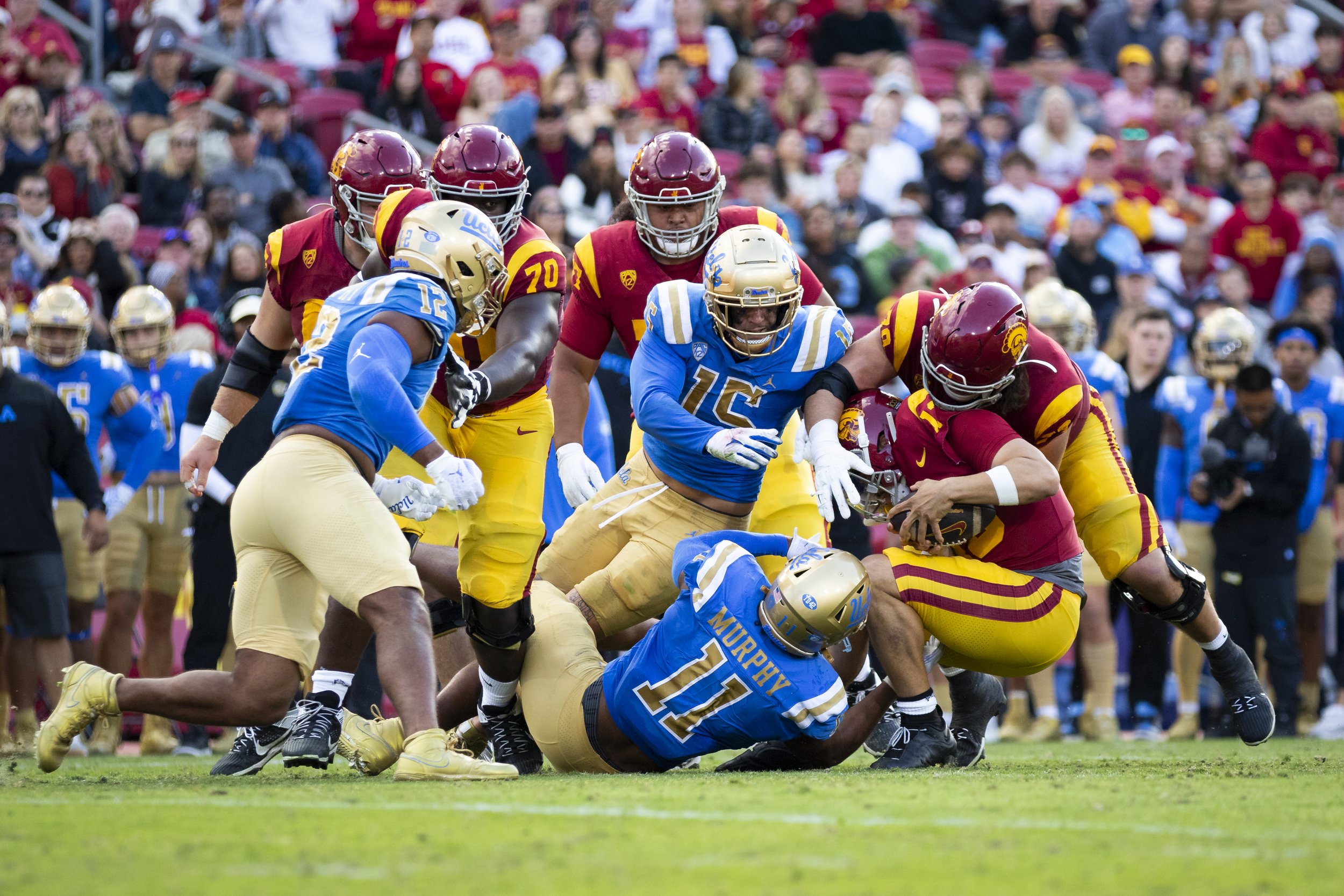  University of Southern California (USC) Trojan quarterback Caleb Williams (center right) being tackled by University of California, Los Angeles (UCLA) Bruins during the second quarter of a football game at the Los Angeles Memorial Coliseum, in Los A