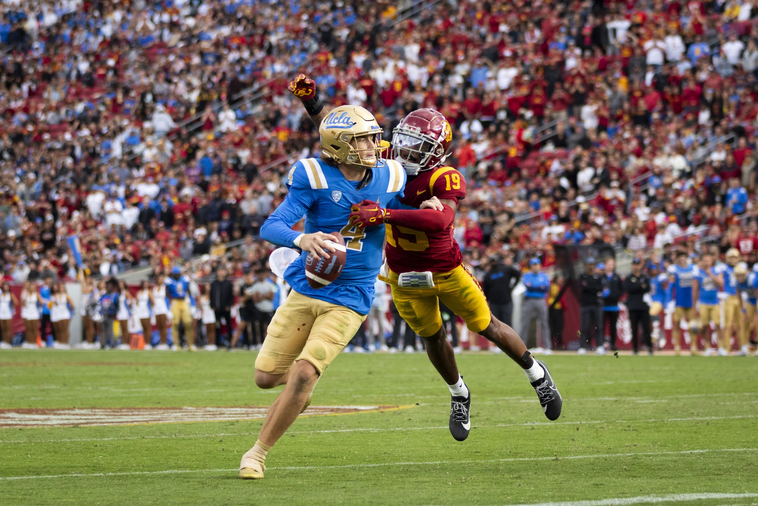  University of California, Los Angeles (UCLA) Bruin quarterback Ethan Garbers (left) being tackled by University of Southern California (USC) Trojan safety Jaylin Smith (right) during the third quarter of a football game at the Los Angeles Memorial C