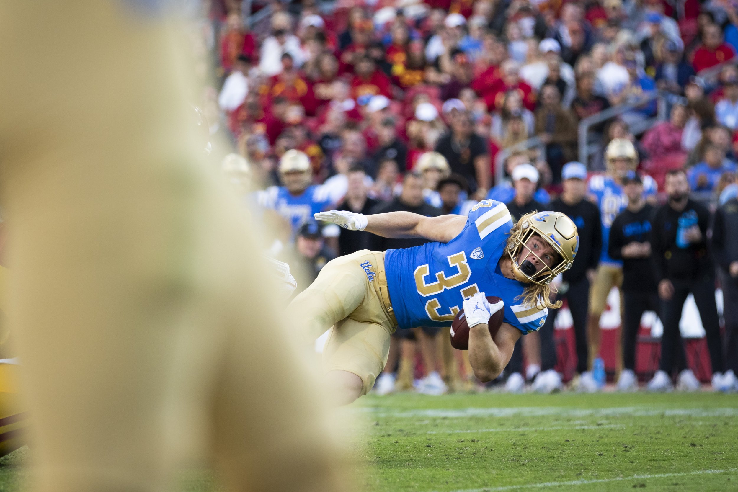  University of California, Los Angeles (UCLA) Bruin running back Carson Steele being tackled by University of Southern California (USC) Trojans during the third quarter of a football game at the Los Angeles Memorial Coliseum, in Los Angeles, Calif., 