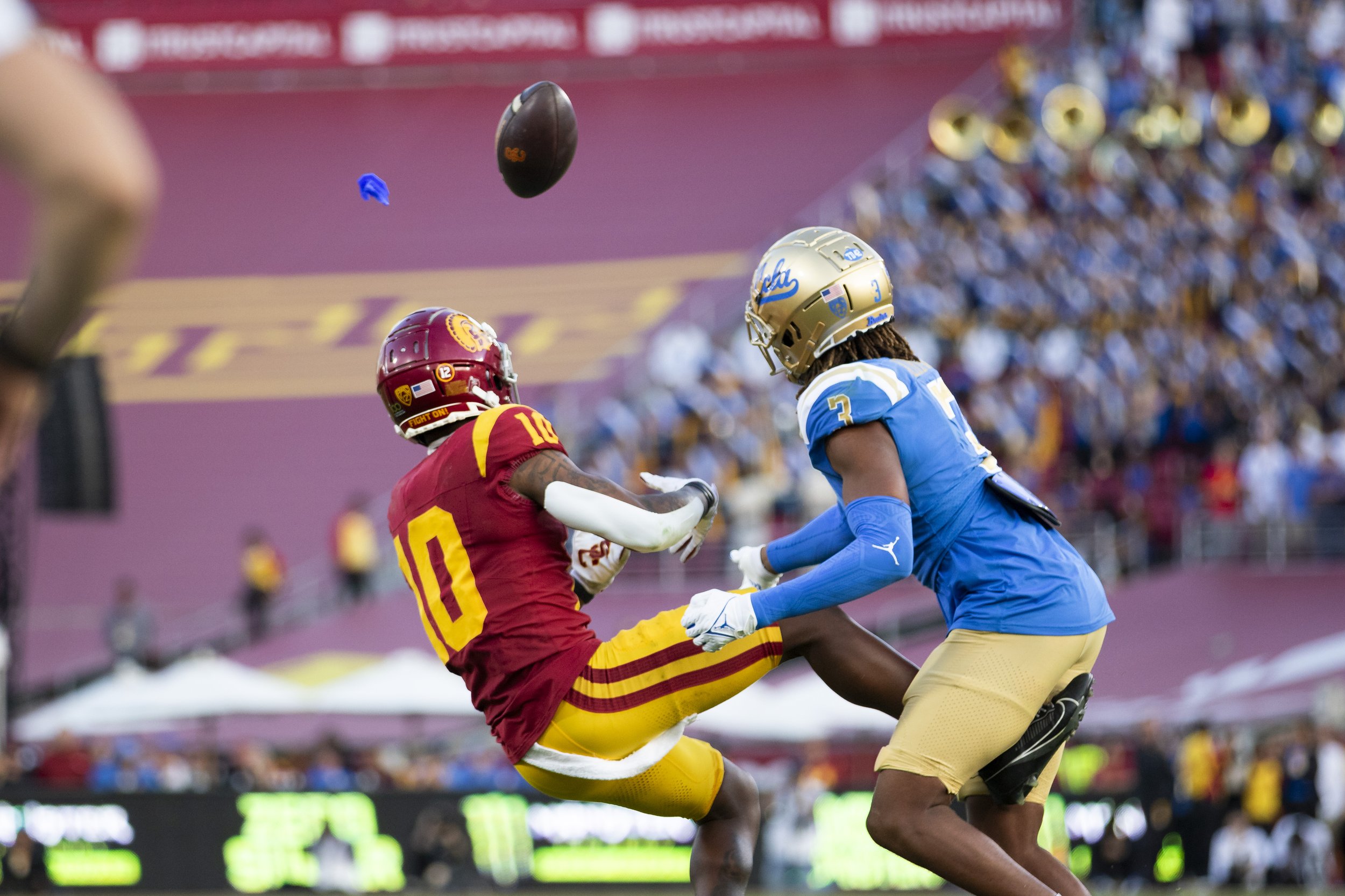  University of Southern California (USC) Trojan wide receiver Kyron Hudson (left) failing to complete a pass while being tackled by University of California, Los Angeles (UCLA) Bruin defensive back Devin Kirkwood (right) during the fourth quarter of 