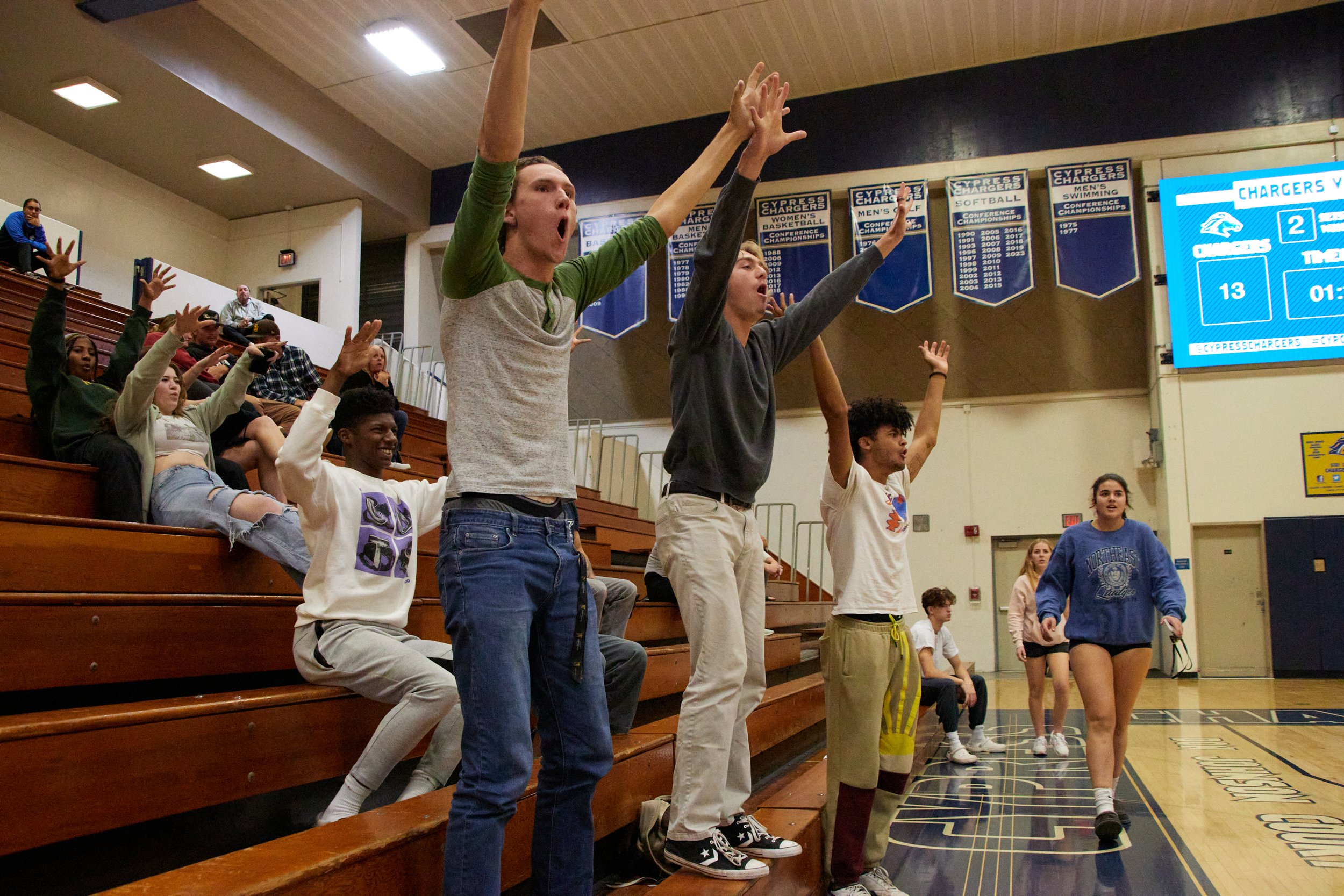  Santa Monica College students (L to R) Peter Dalton Droog, Bryce Bowsher, and Nate Davis cheering during the fith set at the women's volleyball match against Cypress College Chargers at Cypress College Gymnasium number 2, Cypress, Calif., on Nov 21,