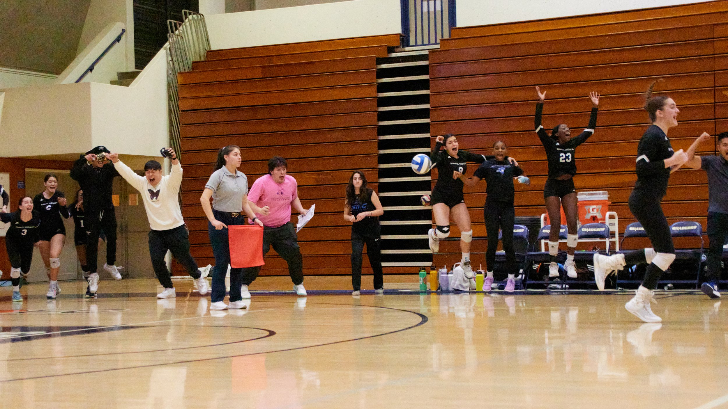  Santa Monica College Corsairs women's volleyball members celebrating in a roar right after the Corsairs won the fifth set during the women's volleyball match against Cypress College Chargers at Cypress College Gymnasium number 2, Cypress, Calif., on