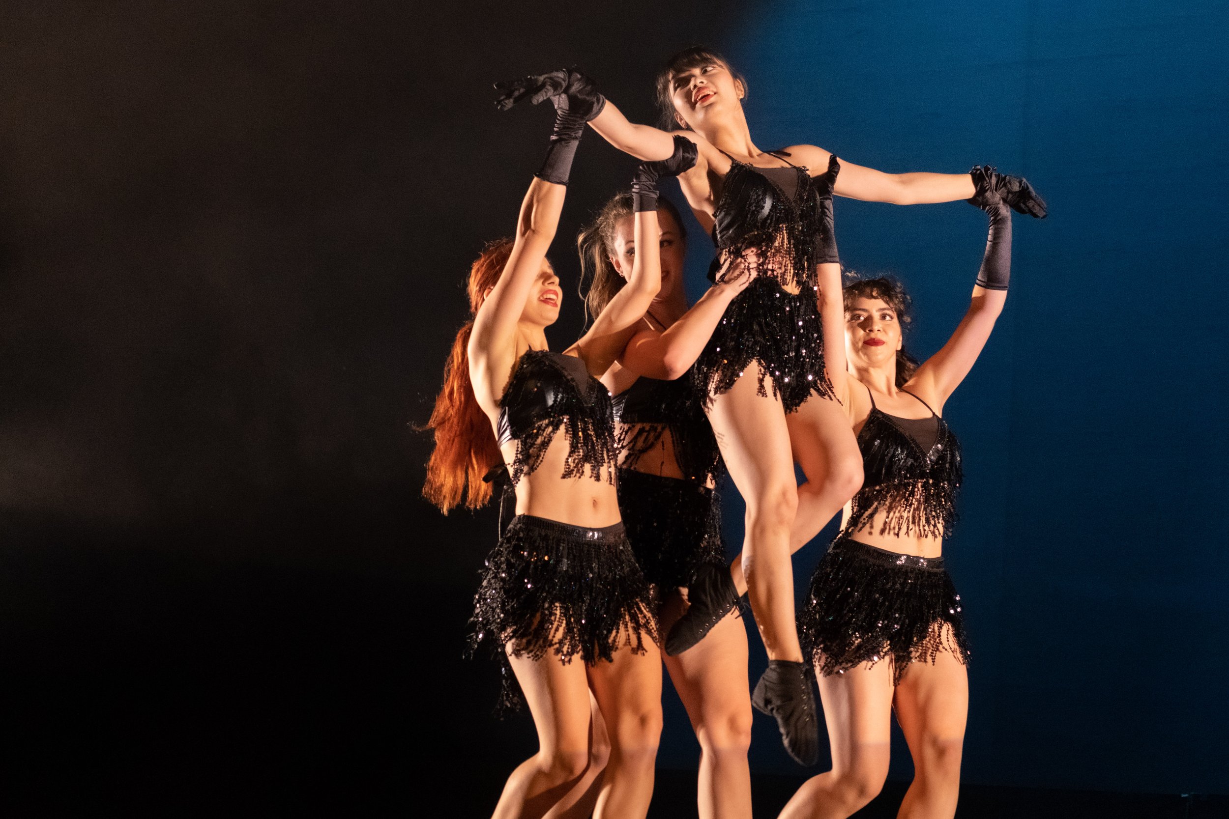  Santa Monica College students (bottom L to R) Angelina Roychenko, Zoe Miller and Sophia Aponte lift dancer Heather Ongpauco as they perform "Ladies First", a Jazz Funk choreography at the dress rehearsal for Global Motion on stage at BroadStage in S
