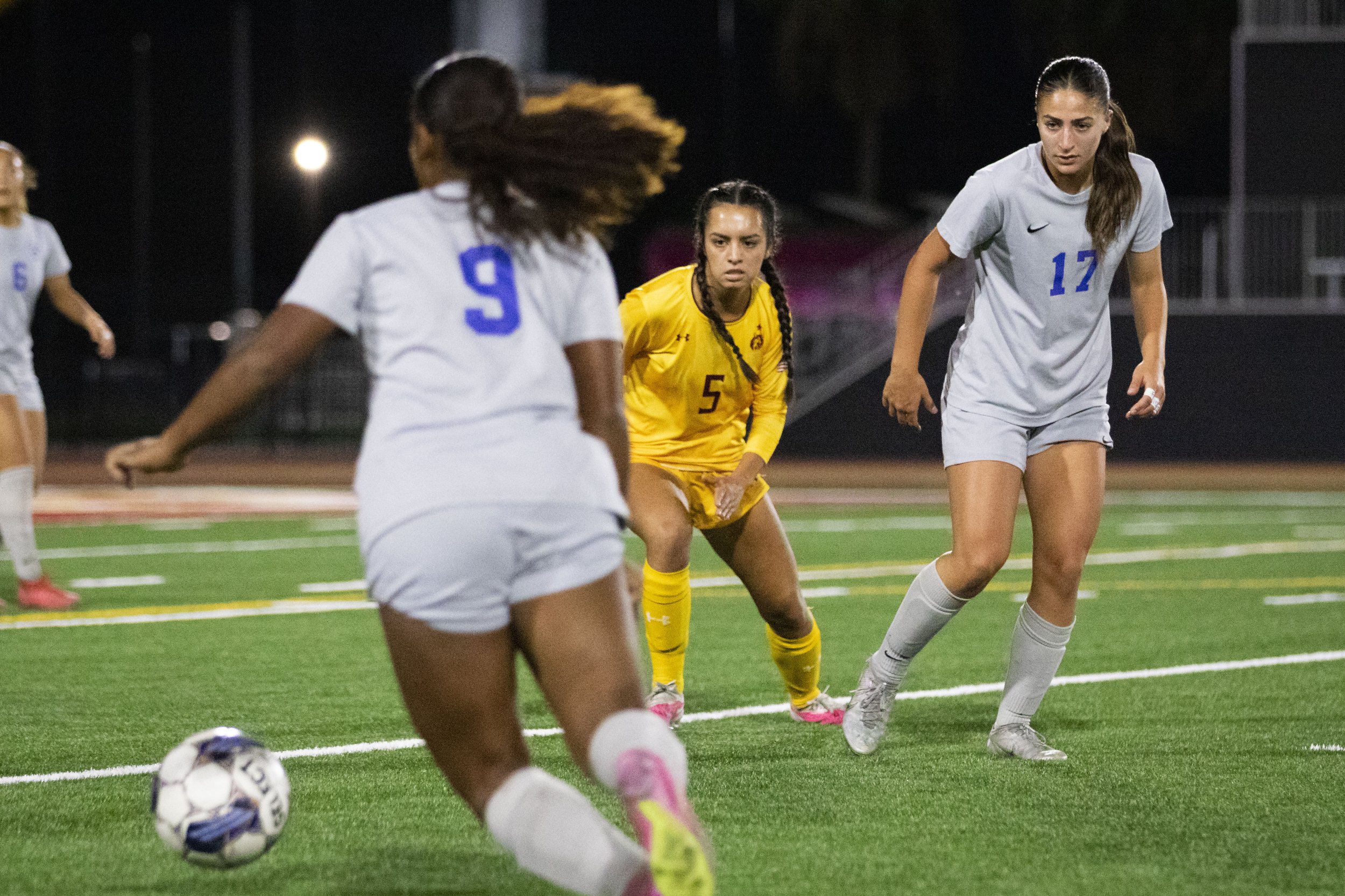 Santa Monica College Corsair forward Jacky Hernandez (right) passes the ball to forward Amarah Martinez (left) after Saddleback College Bobcat midfielder Danyela Jara attempted to take it from her at in the first half of a soccer game Saddleback Col