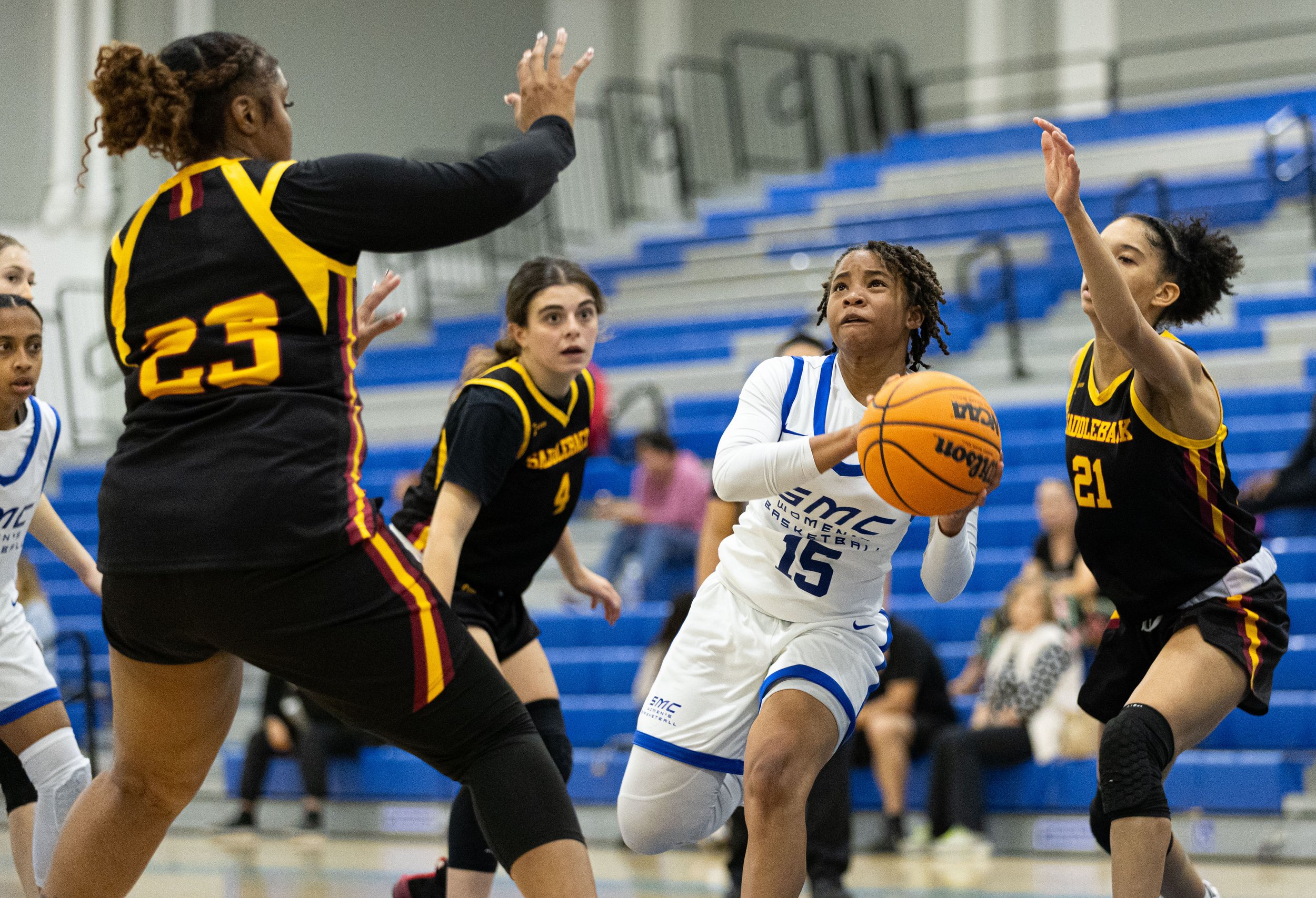  Corsair guard Jayahne Henderson(15) from Santa Monica College(SMC) going for the layup against Saddleback College Bobcat Serenity Fields(23) in the SMC Pavillion Gym at Santa Monica, Calif. Corsairs lost 62-50 to put them in a 3-game losing streak o