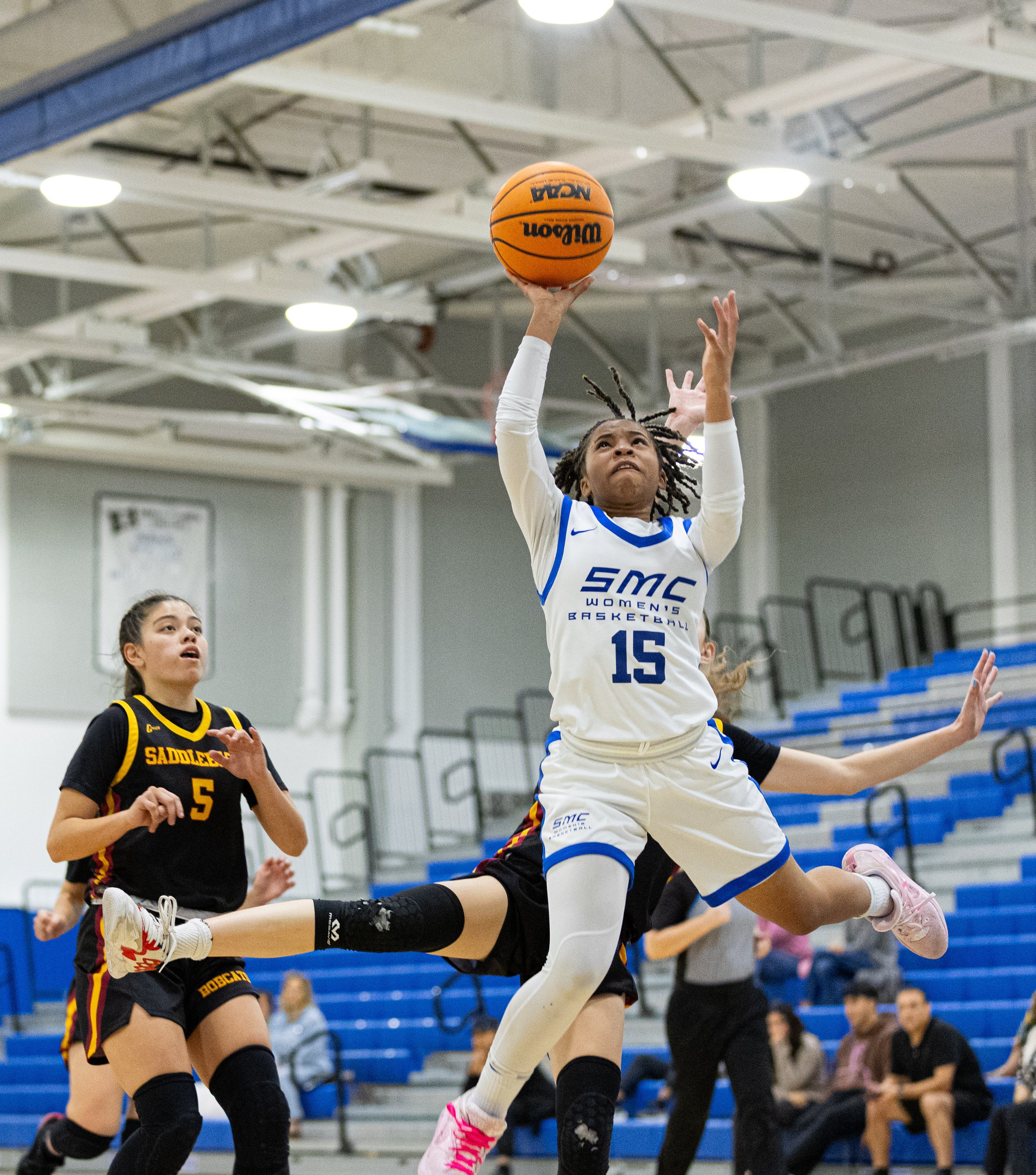  Corsair guard Jayahne Henderson(15) from Santa Monica College(SMC) getting passed Saddleback College Bobcat players for the layup in the SMC Pavillion Gym at Santa Monica, Calif. Corsairs lost 62-50 to put them in a 3-game losing streak on Tuesday, 