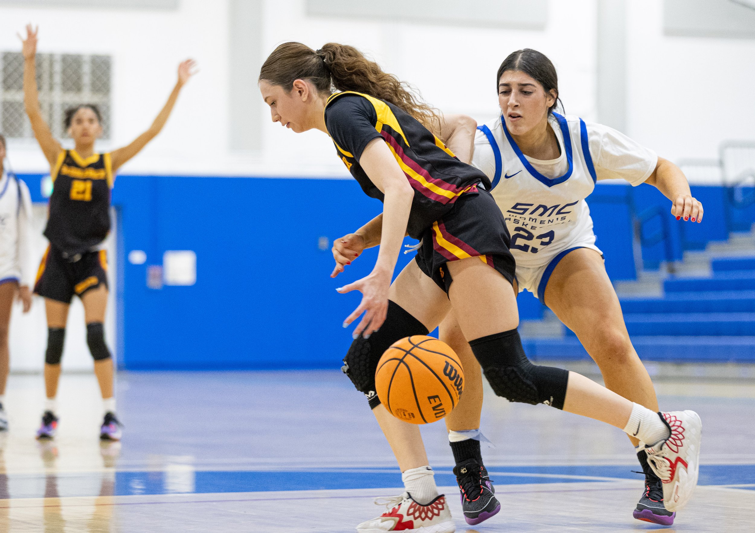  Corsair forward Nicole Mansouri(23) from Santa Monica College(SMC) attempting to stop Saddleback College Bobcat Aleksia Gadea(L) from making it to the other side of the court in the SMC Pavillion Gym at Santa Monica, Calif. Corsairs lost 62-50 to pu