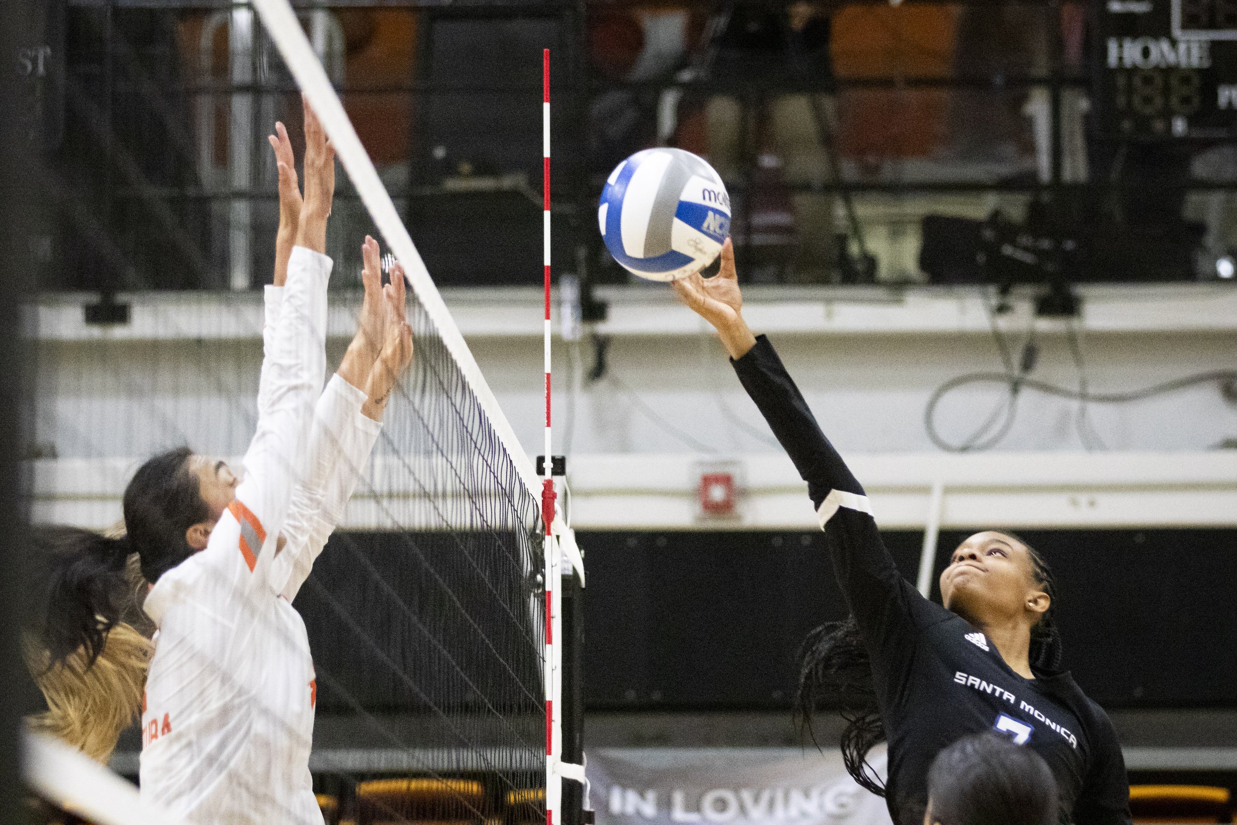  Santa Monica College Corsair opposite Zarha Stanton (right) attempting to tip the ball over the net during the Volleyball SoCal Regional Final against the Ventura College  Pirates at Ventura College in Ventura, Calif., on Saturday, Nov. 25, 2023. Th