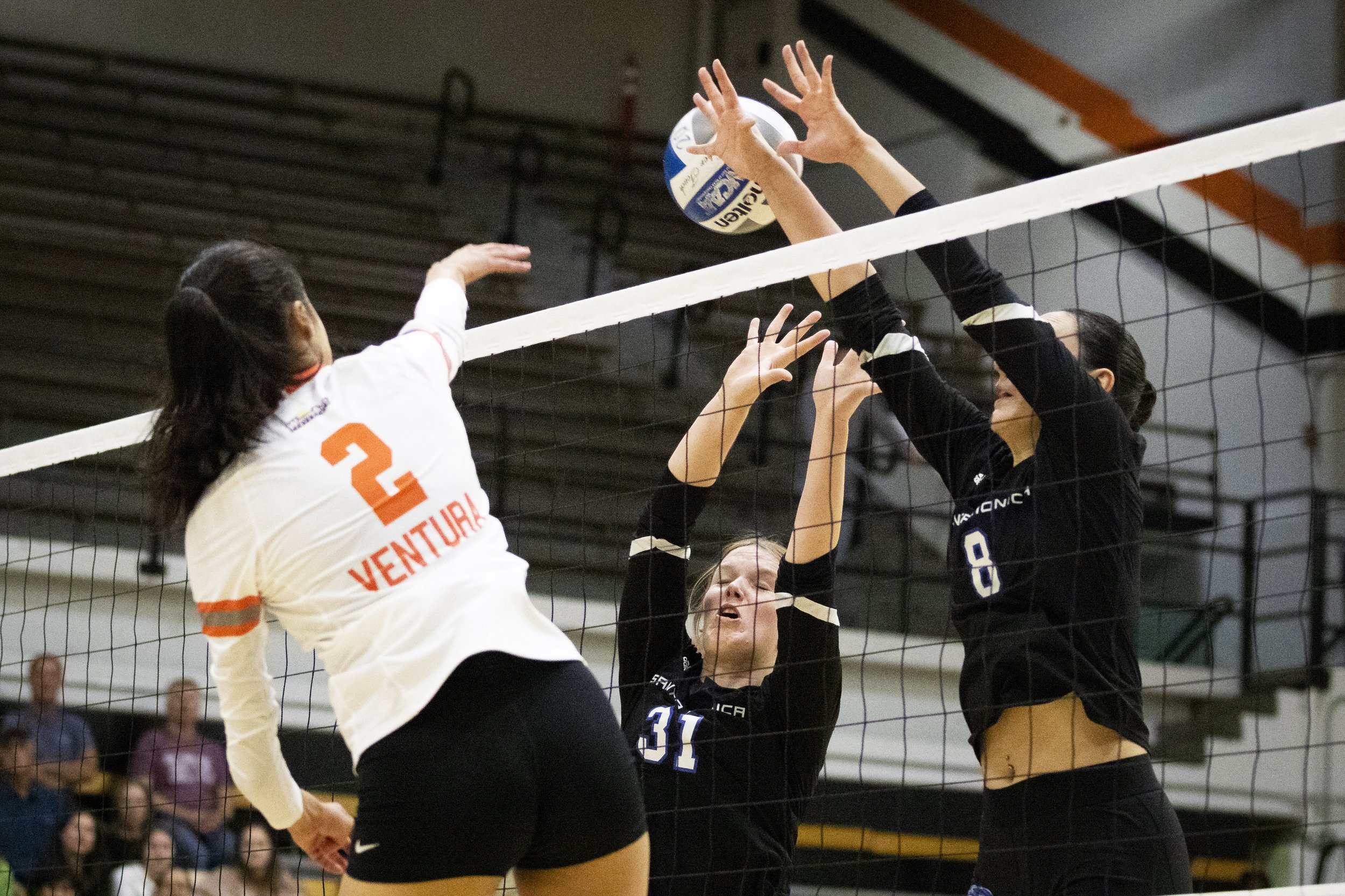  Santa Monica College Corsairs middle blocker Mylah Niksa (center) and outside hitter Natalie Fernandez attempt to block a spike by Ventura College Pirate middle hitter Brianna Morrison during the Volleyball SoCal Regional Final at Ventura College in