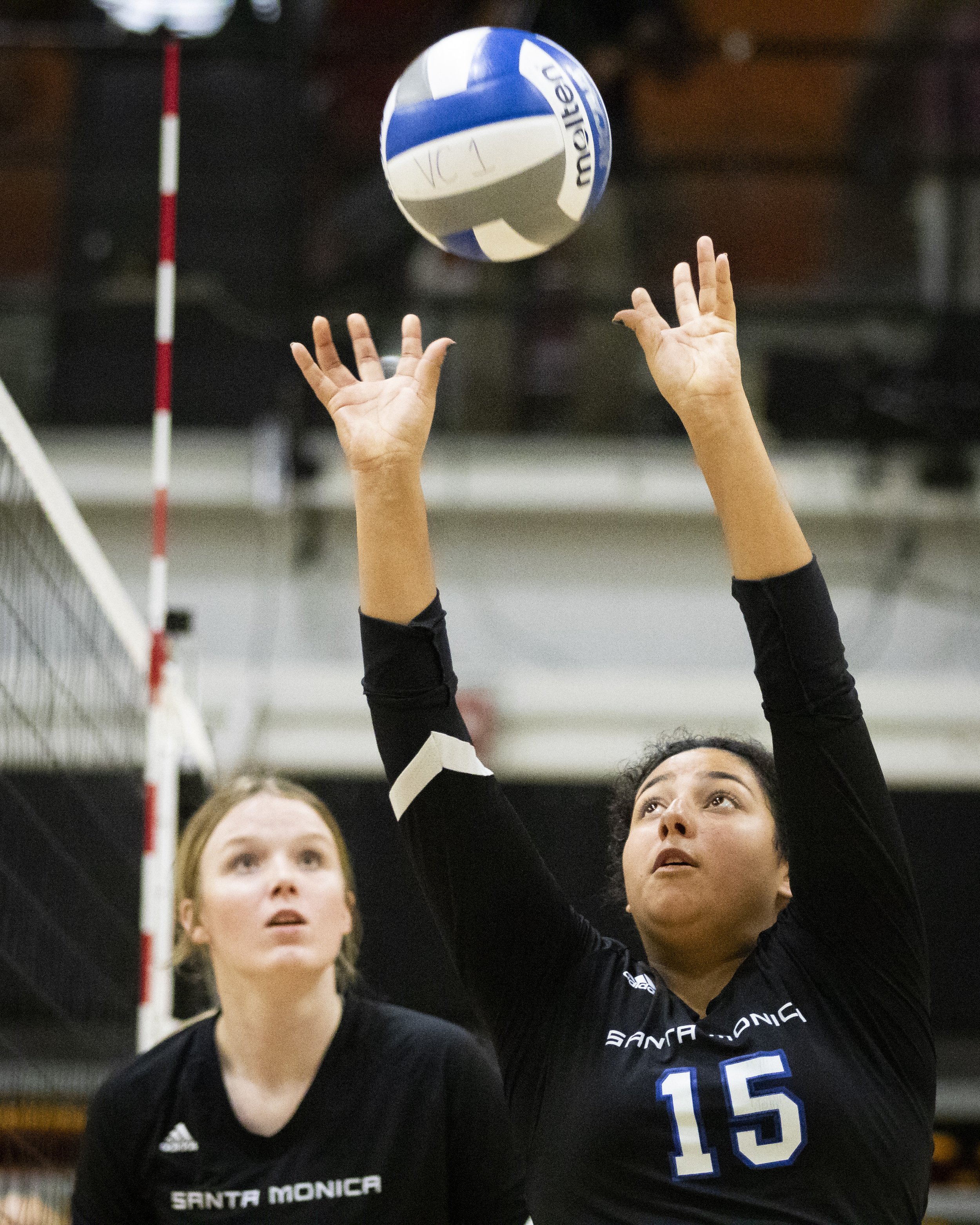  Santa Monica College Corsair setter Jaylnn Fierro (right) setting the ball up for a spike during the Volleyball SoCal Regional Final against the Ventura College  Pirates at Ventura College in Ventura, Calif., on Saturday, Nov. 25, 2023. The Corsairs