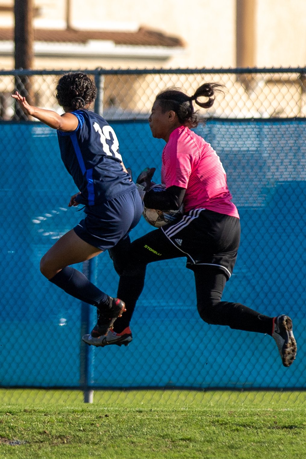  Santa Monica Corsairs' goalkeeper Giorgia Sterza (0) catches the ball while Cypress Charger forward Carisia Raygoza (12) attempts to block during the women's soccer match on Saturday, Nov. 25, 2023 at Cypress College in Cypress, Calif.  (Akemi Rico 