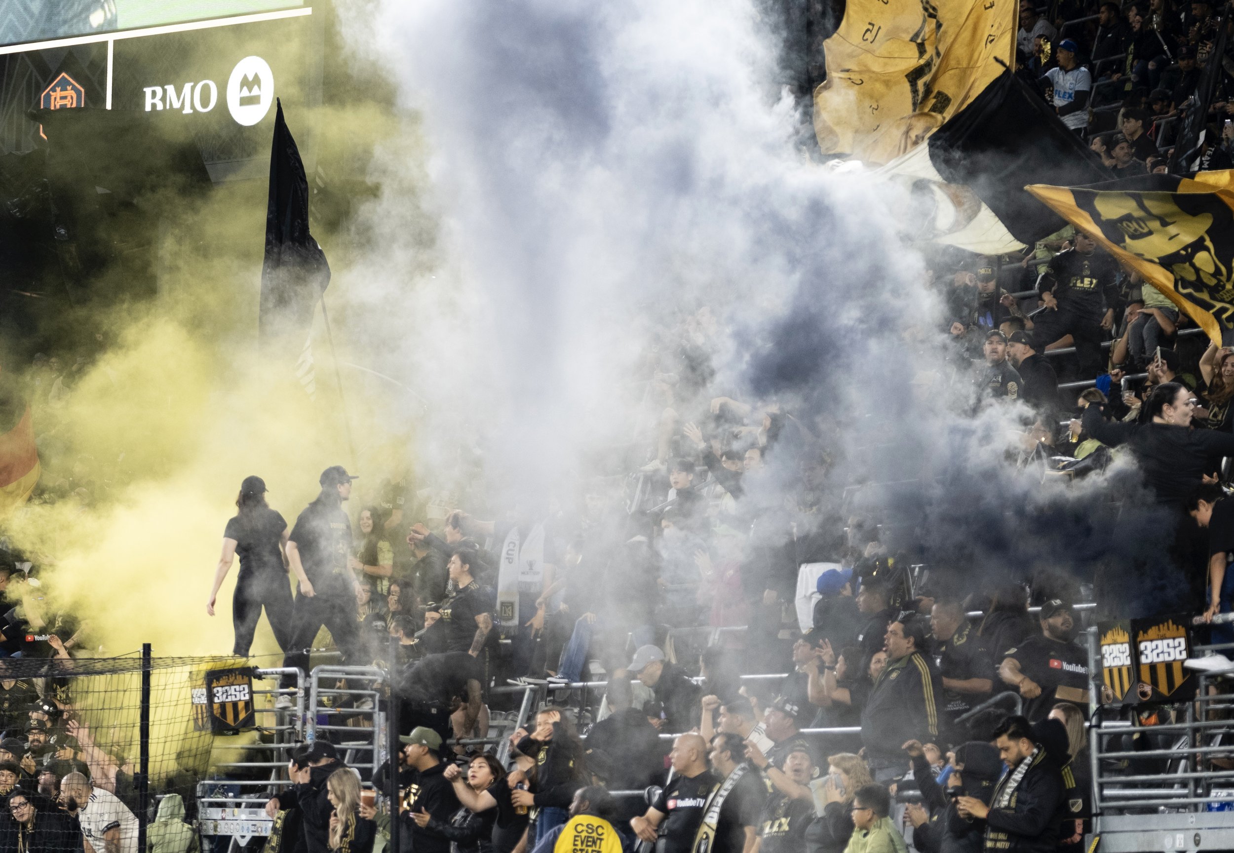  Smoke rises as Los Angeles Football Club (LAFC) supporters cheer on the team as they face off with Houston Dynamo FC in a Major League Soccer (MLS) match on Wednesday, June 14, at the Bank of Montreal (BMO) Stadium in Los Angeles, California. (Anna 