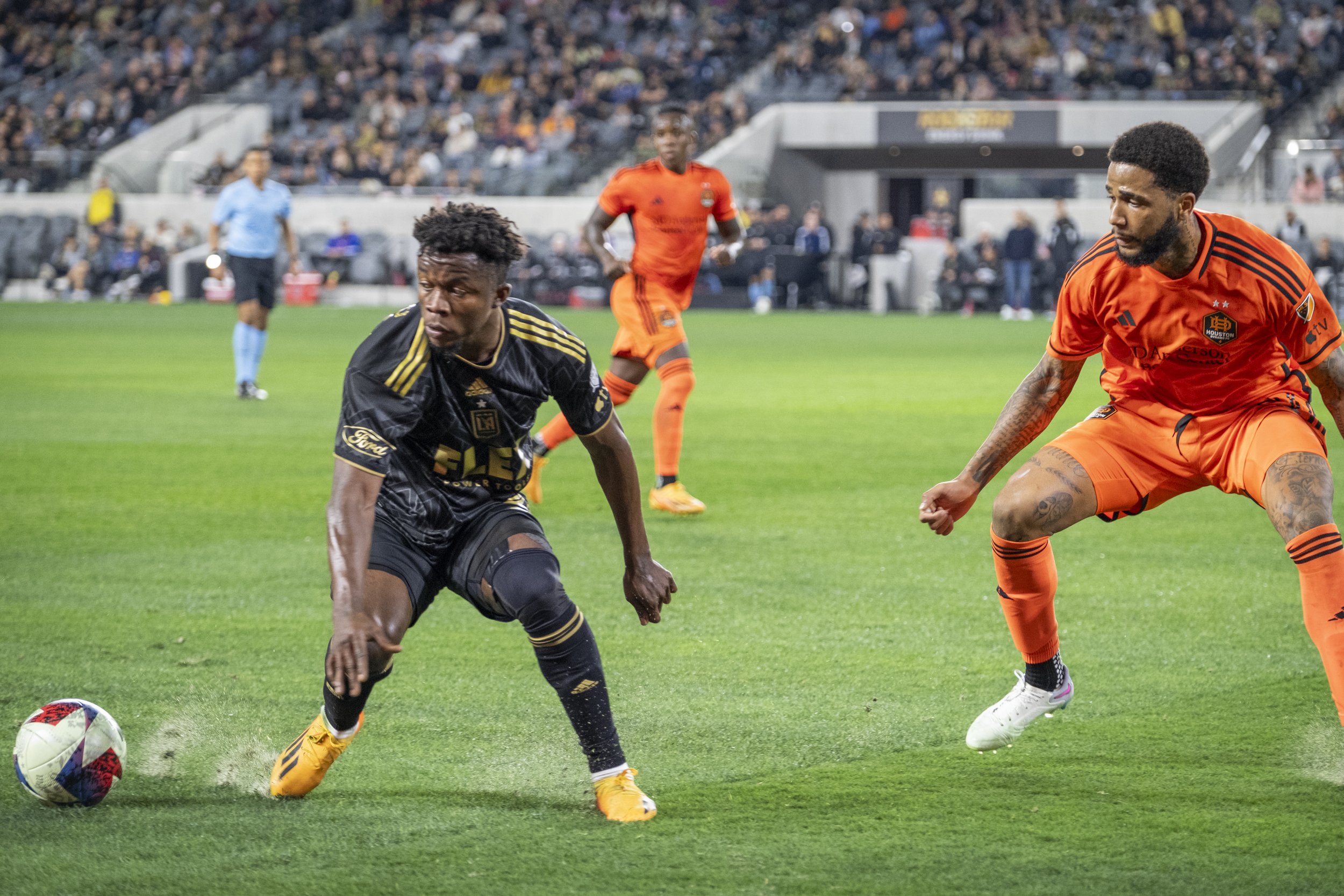  Kwadwo Opoku, Forward #22 of LAFC, and Micael dos Santos Silva Defender #31 of the Houston Dynamo run for the ball during the Major League Soccer (MLS) match on Wednesday, June 14, at the Bank of Montreal (BMO) Stadium in Los Angeles, California. (A