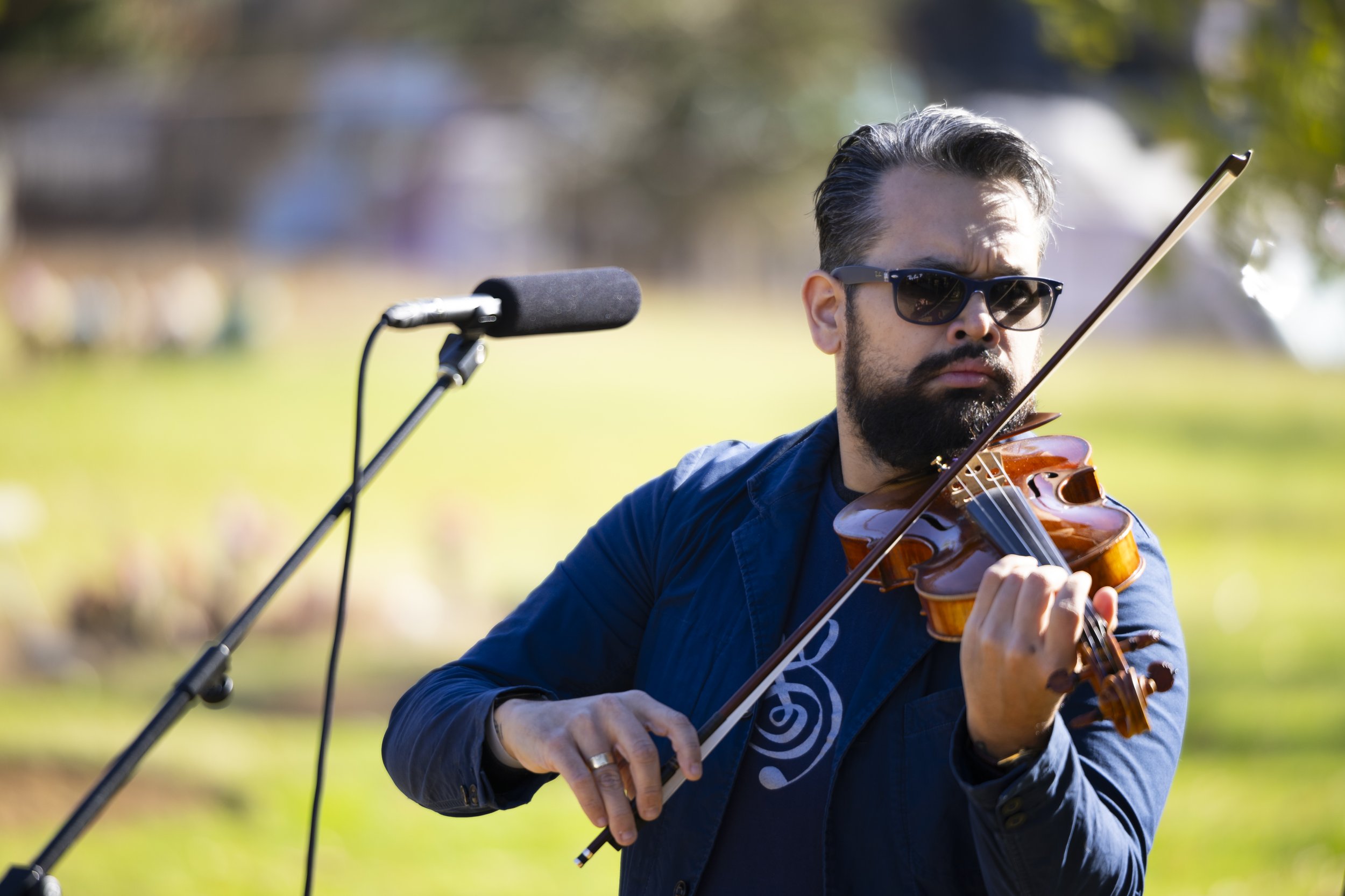  A violinist plays before the Los Angeles County Ceremony of the Unclaimed Dead starts at the LA County Cemetery, in Los Angeles, Calif., on Thursday, Dec. 14, 2023. The ceremony honored 1,937 individuals who died in 2020 and either did not have next