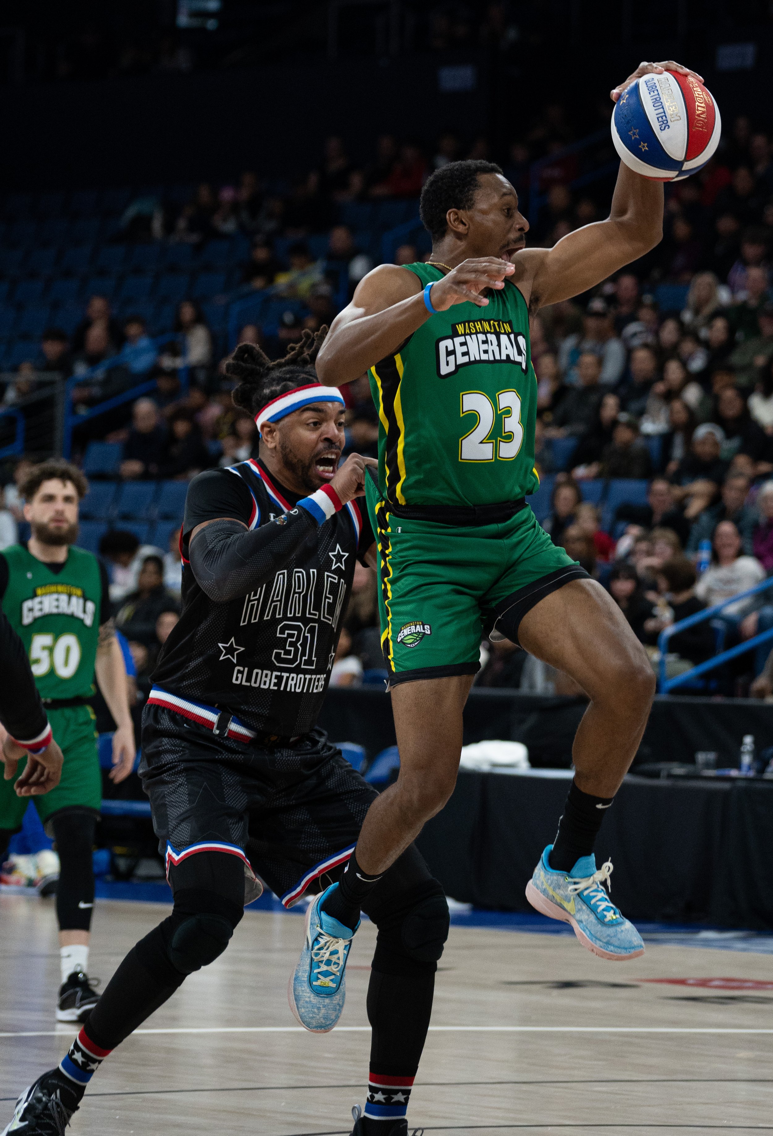  Harlem Globetrotter showman Hammer Harrison(31) pulls up Washington Generals player Johnsons(23) shorts as he goes for the dunk at Toyota Arena in Ontorio, Calif. on Monday, Feb.19, 2024. (Danilo Perez | The Corsair) 