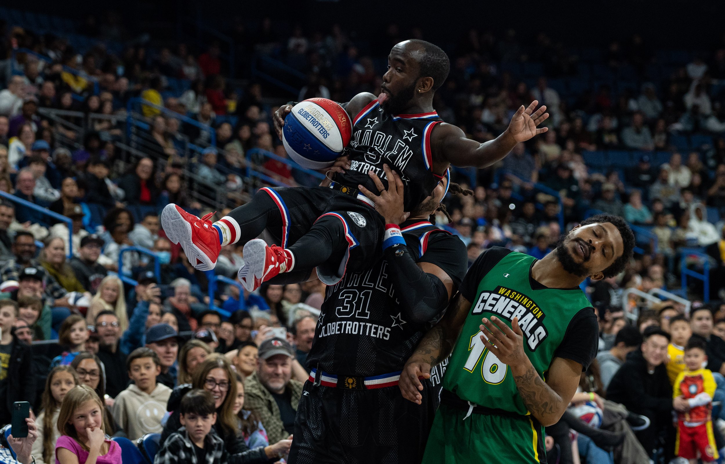  Harlem Globetrotter guard Hot Shot Swanosn gets held up by showman Hammer Harrison at Toyota Arena in Ontorio, Calif. on Monday, Feb.19, 2024. (Danilo Perez | The Corsair) 