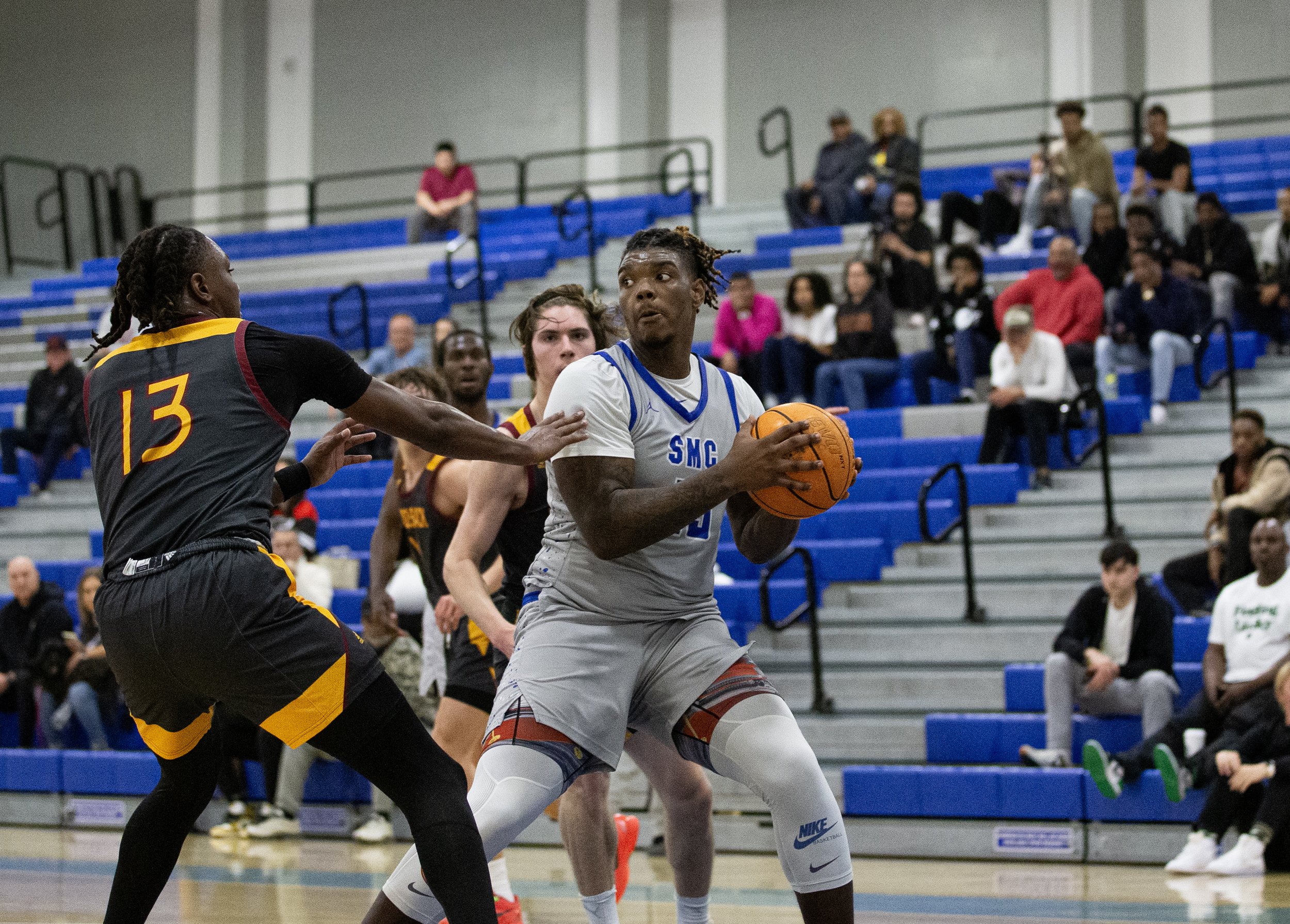  Santa Monica College(SMC) Corsair power forward David Solomon(15) attempts to get past Saddleback Bobcat forward James Burries(13) on Wednesday, Feb. 28, 2024. Corsairs lost the playoff game against the Bobcats 75-72 at the SMC Pavillion in Santa Mo