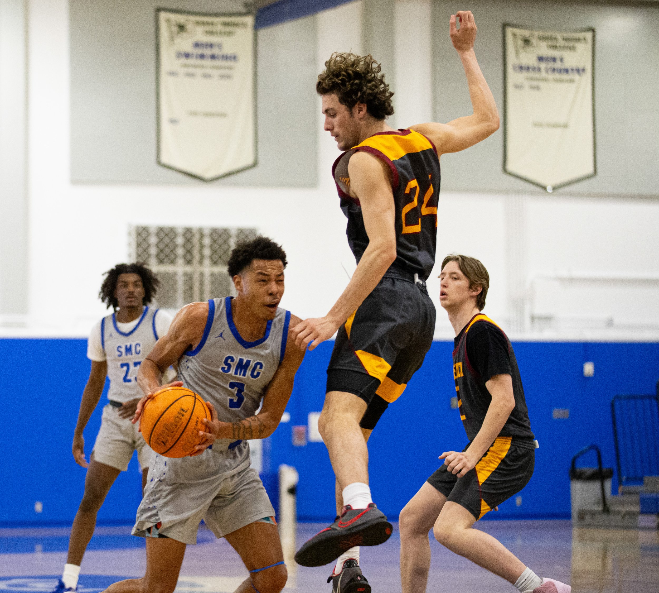  Santa Monica College(SMC) Corsair shooting guard Raymond Watts(3) fakes out Saddleback Bobcat forward Charlie Stallings(24) on Wednesday Feb. 28, 2024. SMC fell short three-points from advancing on in the playoffs with a final score of 75-73 at SMC 
