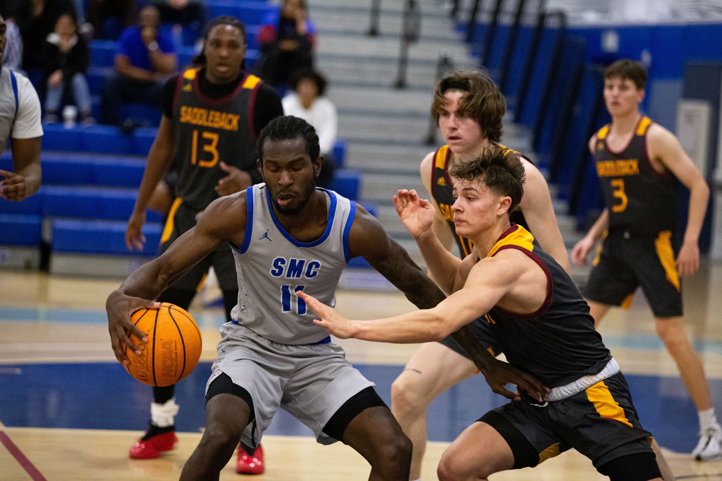  Santa Monica College(SMC) Corsair power guard Thomas Gilgeous-Alexander(11) attempts to get past Saddleback Bobcat players on Wednesday Feb. 28, 2024. SMC fell short three-points from advancing on in the playoffs with a final score of 75-73 at SMC P