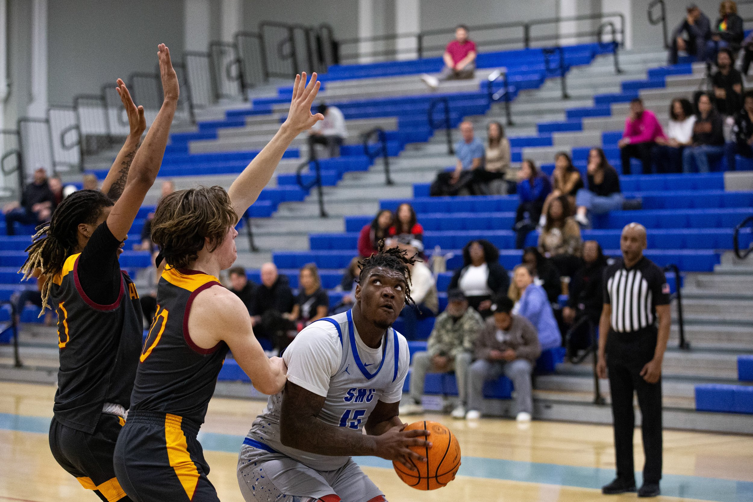  Santa Monica College(SMC) Corsair power forward David Solomon(15) looks up towards the basket while being blocked by Saddleback Bobcat players on Wednesday Feb. 28, 2024. SMC fell short three-points from advancing on in the playoffs with a final sco