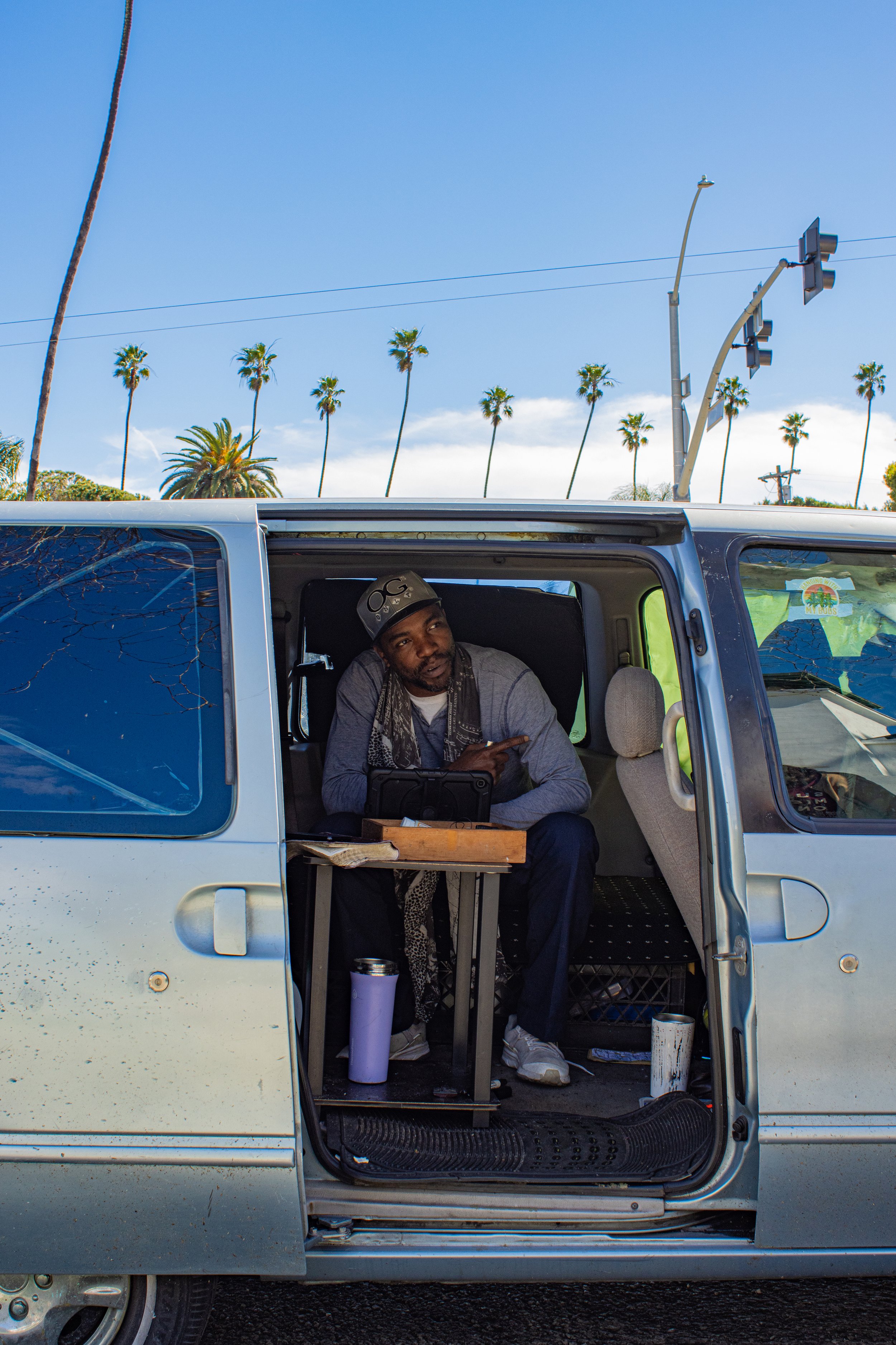  Pat Raphael, 44, Venice,  Los Angeles, Calif. Wednesday, Feb. 21, 2024. With Palm tress as the background, Pat sits in his car made home and talks about the intricacies of his living situation and dealing with various authorites and other unhoused p