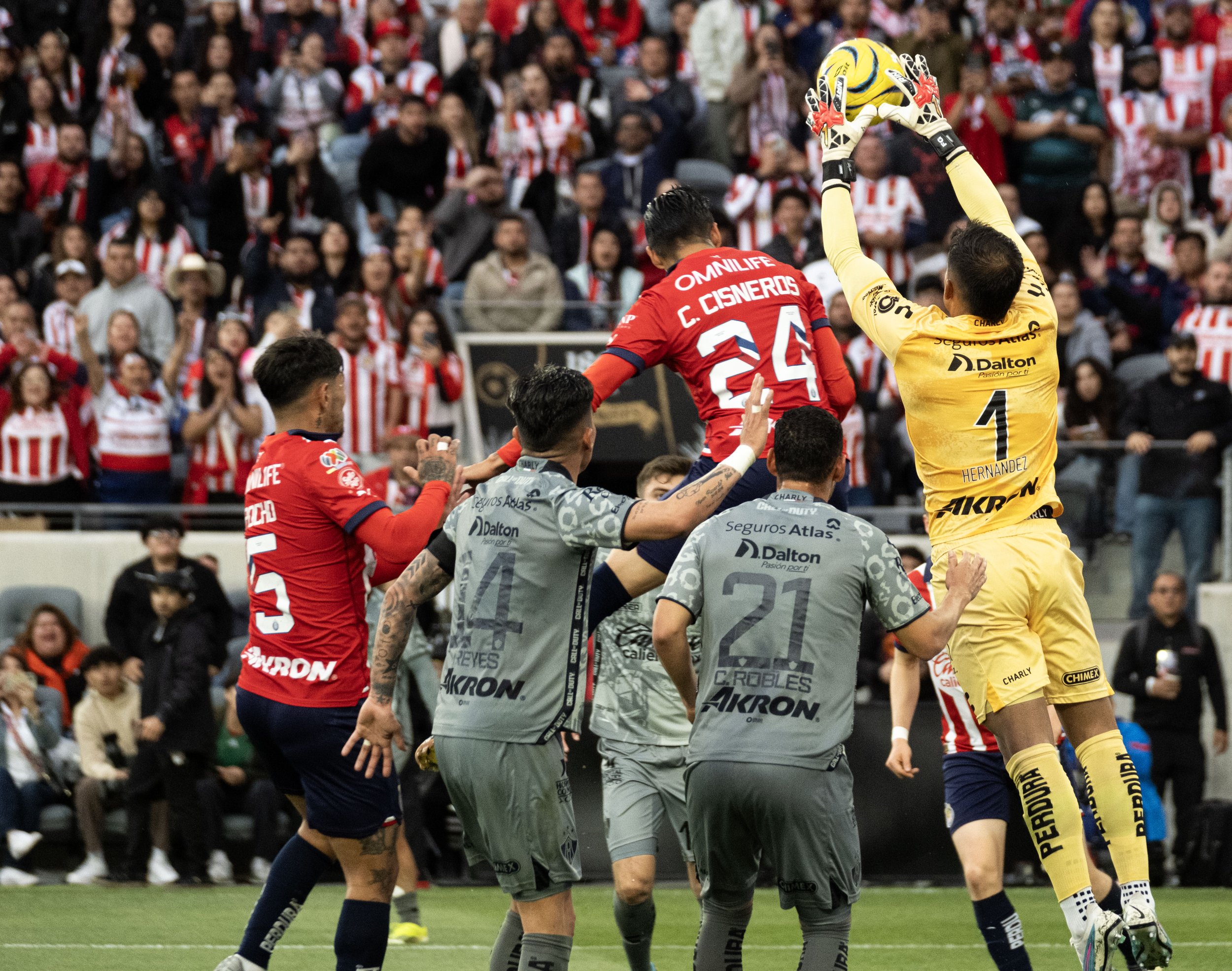  Atlas F.C. goalkeeper Jose Hernandez(1) jumps to catch the ball before Chivas midfielder Carlos Cisneros(24) can get to during their derby on Sunday, March 24 in BMO Stadium at Los Angeles, Calif. (Danilo Perez | The Corsair) 