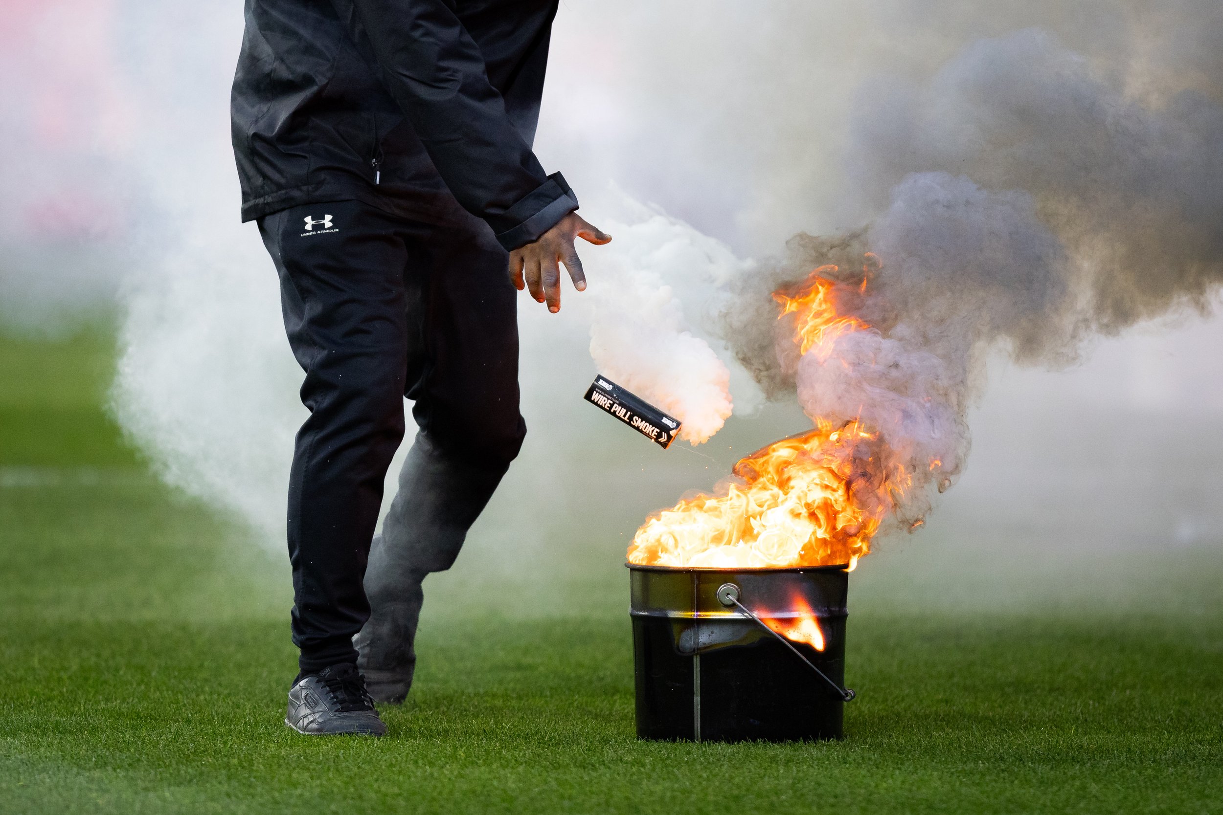  Event staff put smoke bombs and flares into a bucket after Club Deportivo Guadalajara (Chivas) fans threw them onto the field, disrupting the game, during the second half of El Clásico Tapatio 2024 at BMO Stadium in Los Angeles, Calif. on Sunday, Ma