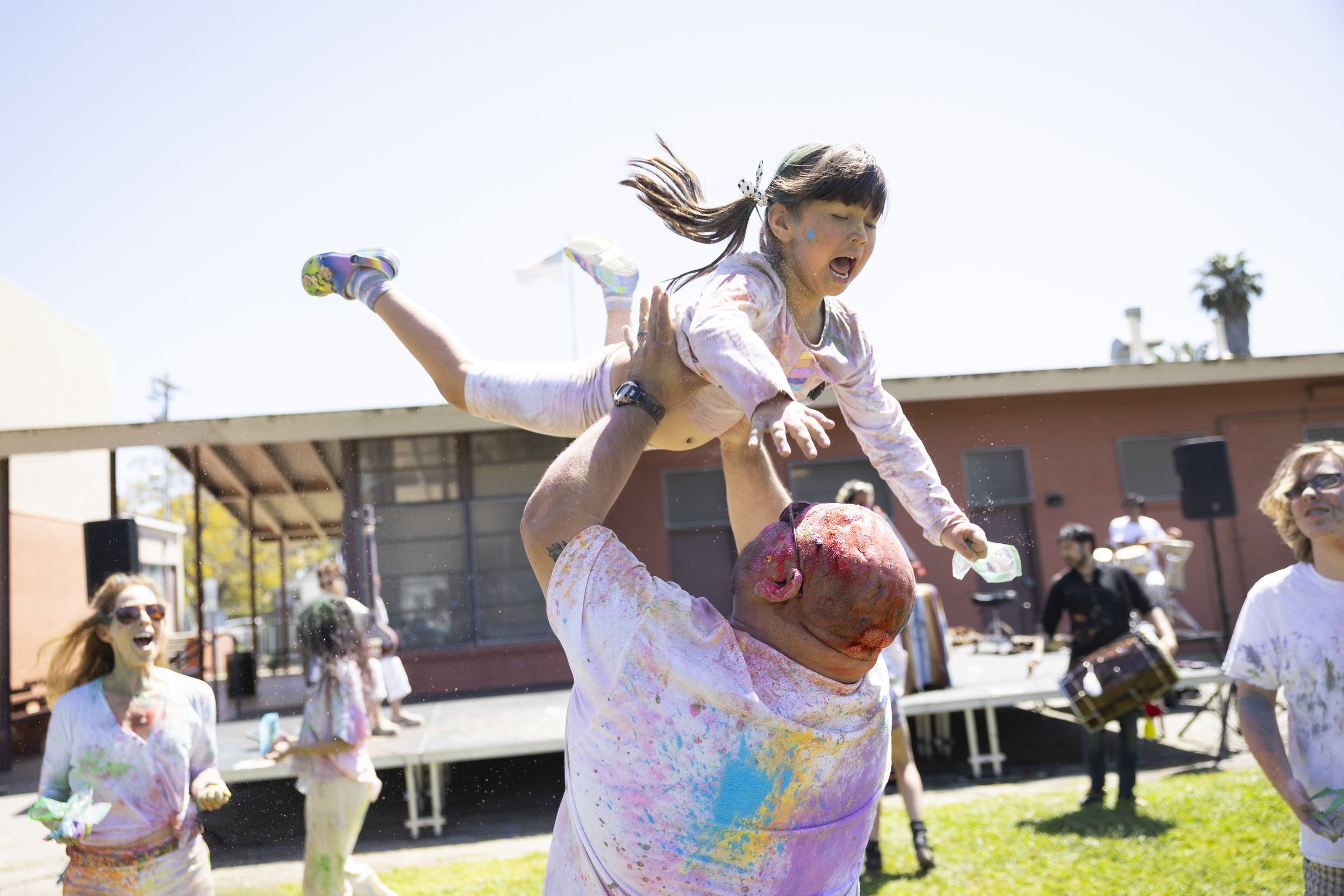  Eric Valadez throws his child into the air at the second annual Venice Holi Celebration at Penmar Park in Los Angeles, Calif., on Sunday, April 7, 2024. Holi, also know as the Festival of Colors, Love, and Spring, is a Hindu festival that celebrates