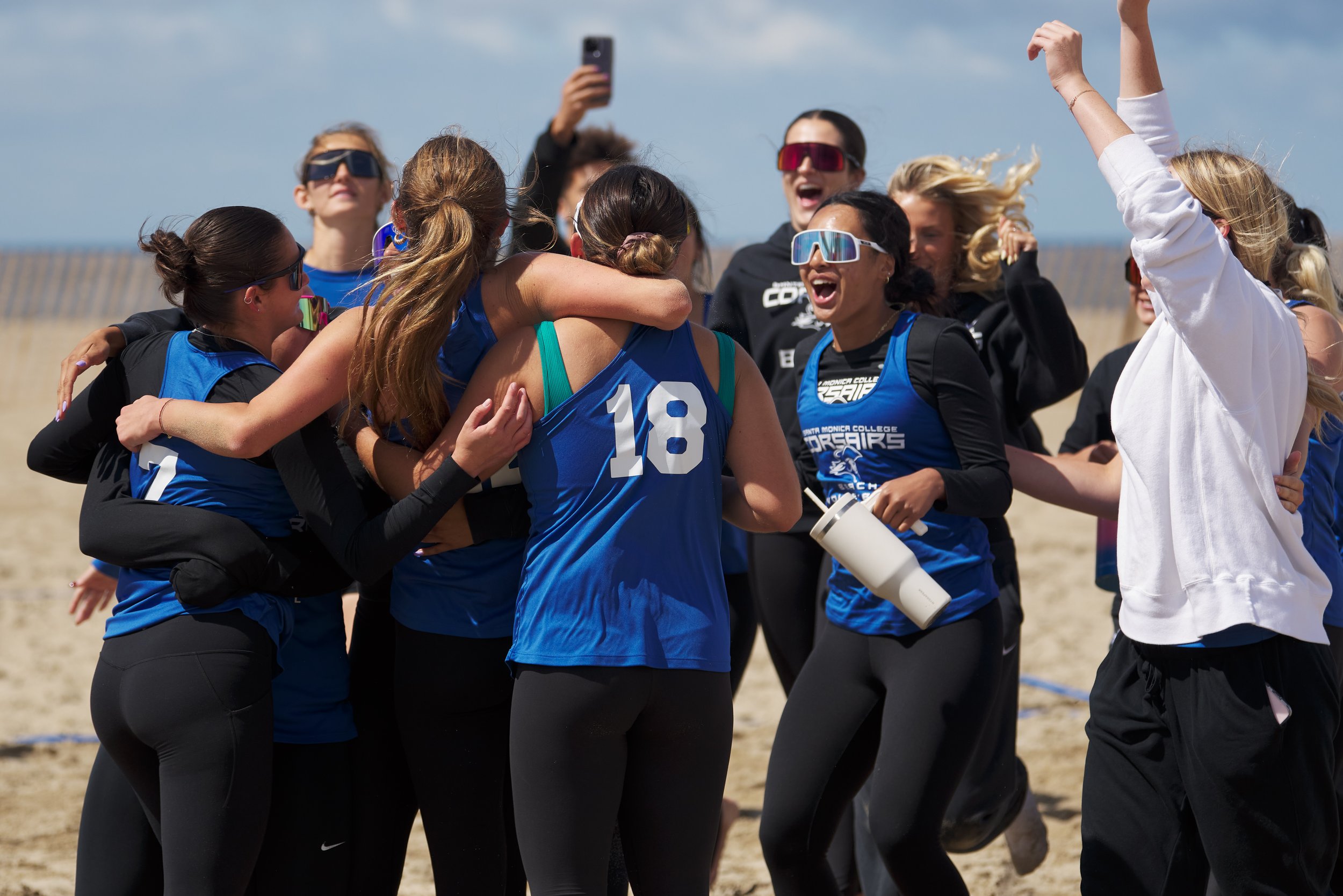  Members of the Santa Monica College Corsairs women's beach volleyball team celebrate after winning the match against the Santa Barbara City College Vaqueros on Friday, April 5, 2024, at Ocean Park in Santa Monica, Calif. The Corsairs won 4-1. (Nicho