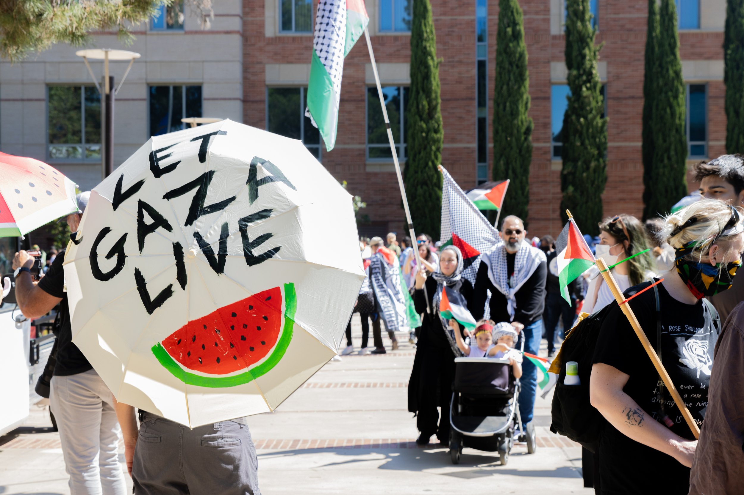  Umbrella held by Palestinian supporter reads "Let Gaza Live" at University of California, Los Angeles, Calif. Sunday, April 28, 2024 (Libna Florencio | The Corsair) 