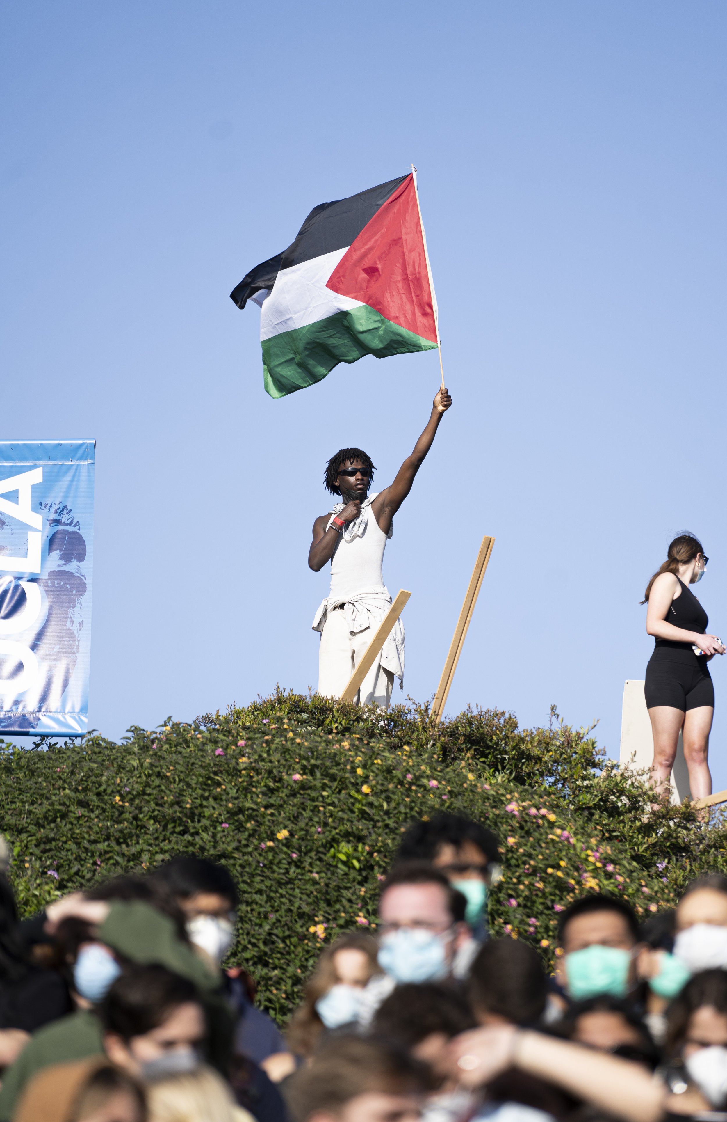  Pro-Palastinian supporter stands within the border of the University of California, Los Angeles(UCLA) encampment while holding a Palastinian flag on Wednesday, May 1 at Dickson Court of UCLA in Los Angeles, Calif. (Danilo Perez | The Corsair) 