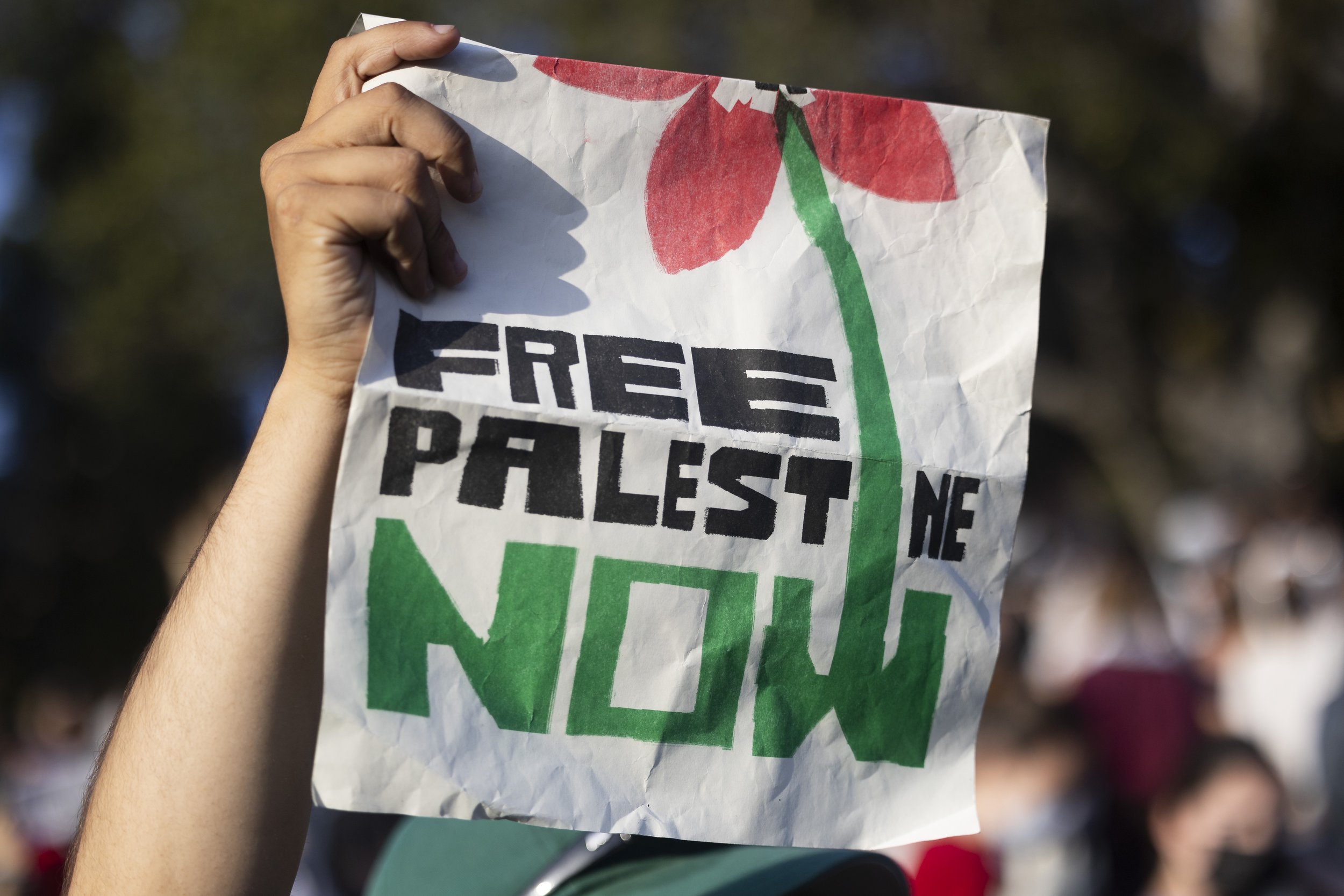  A protesters holds a sign outside the encampment at University of California, Los Angeles supporting Gaza in the Israeli-Palestine Conflict on in Los Angeles, Calif., on Wednesday, May 1, 2024. The protest was organized to defend the encampment from