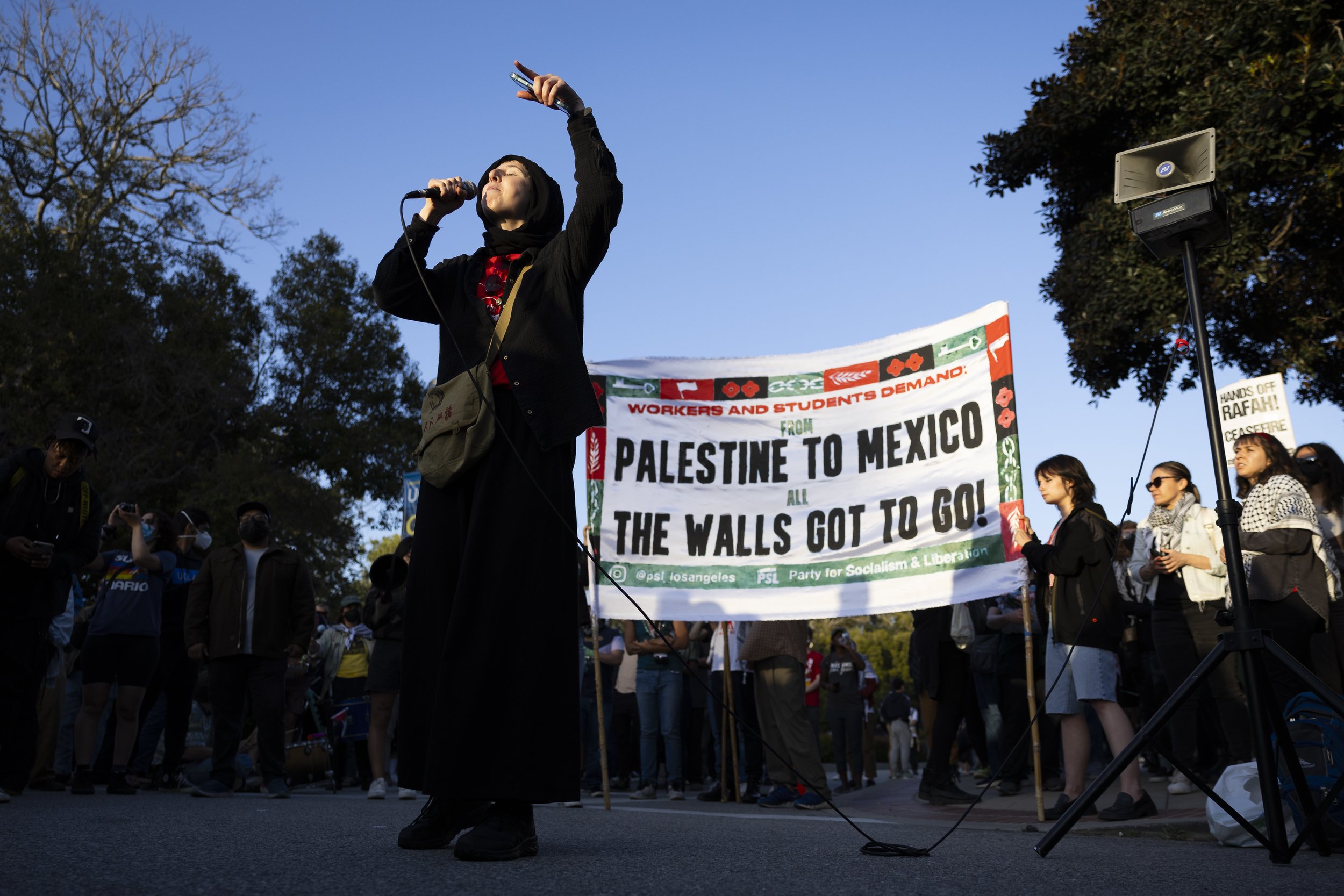  A protester leads chants outside the encampment at University of California, Los Angeles supporting Gaza in the Israeli-Palestine Conflict on in Los Angeles, Calif., on Wednesday, May 1, 2024. The protest was organized to defend the encampment from 