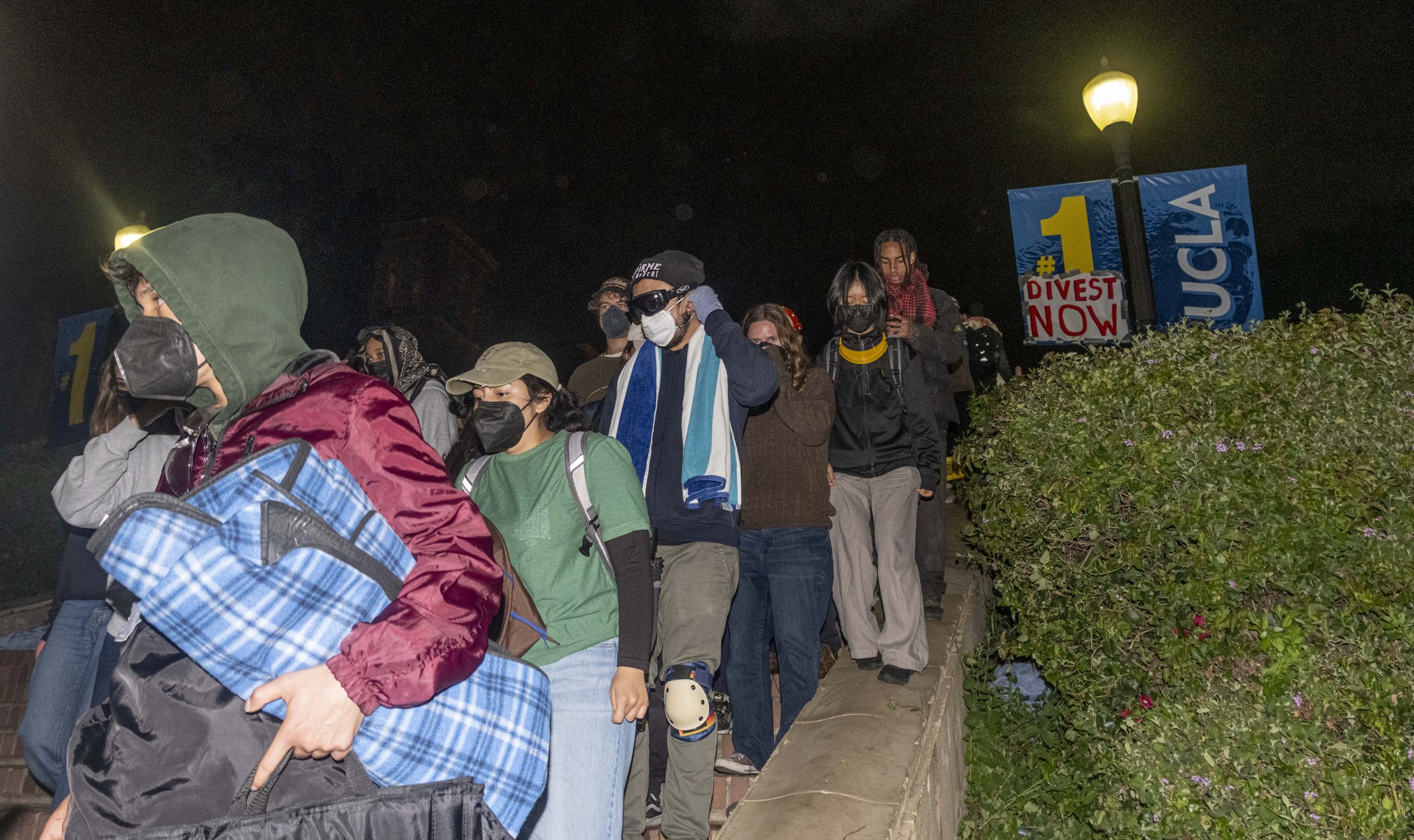  Pro-Palastinian supporters retreat down the stairs heading towards Wilson Plaza after California Highway Patrol Special Operations Unit successfully clears half the encampment at Dickson Court in the University of California, Los Angeles on Wednesda