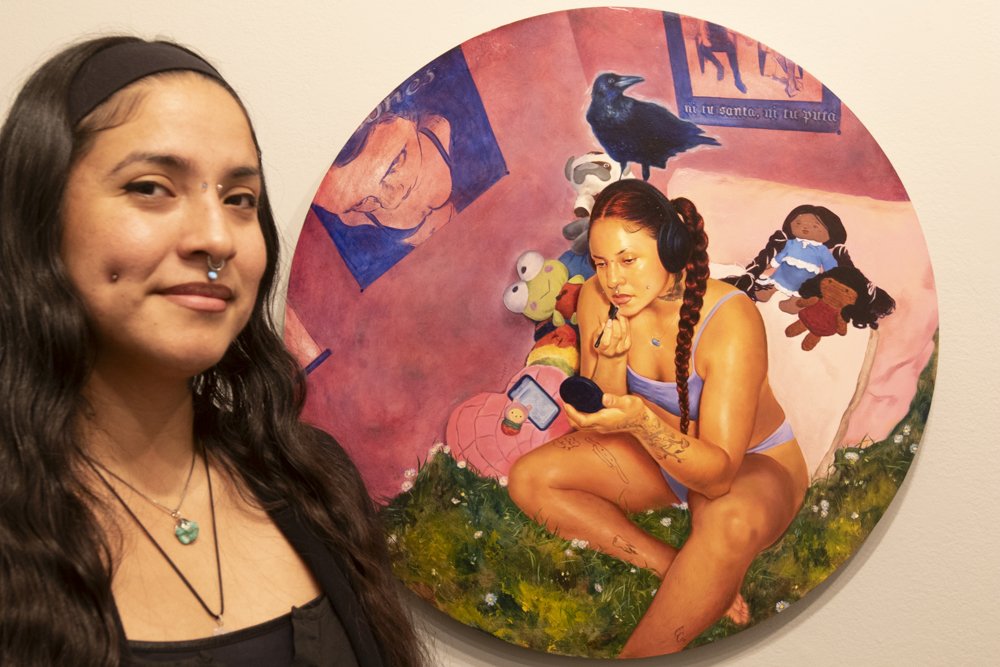  Emilia Cruz with her painting,  that is in the exhibit Arte Chicano Hecho En Los Angeles that is currently showing at the California Heritage Museum, it is on view through June 2, 2024, a pop up with some of the artist was held Saturday April 6, 202