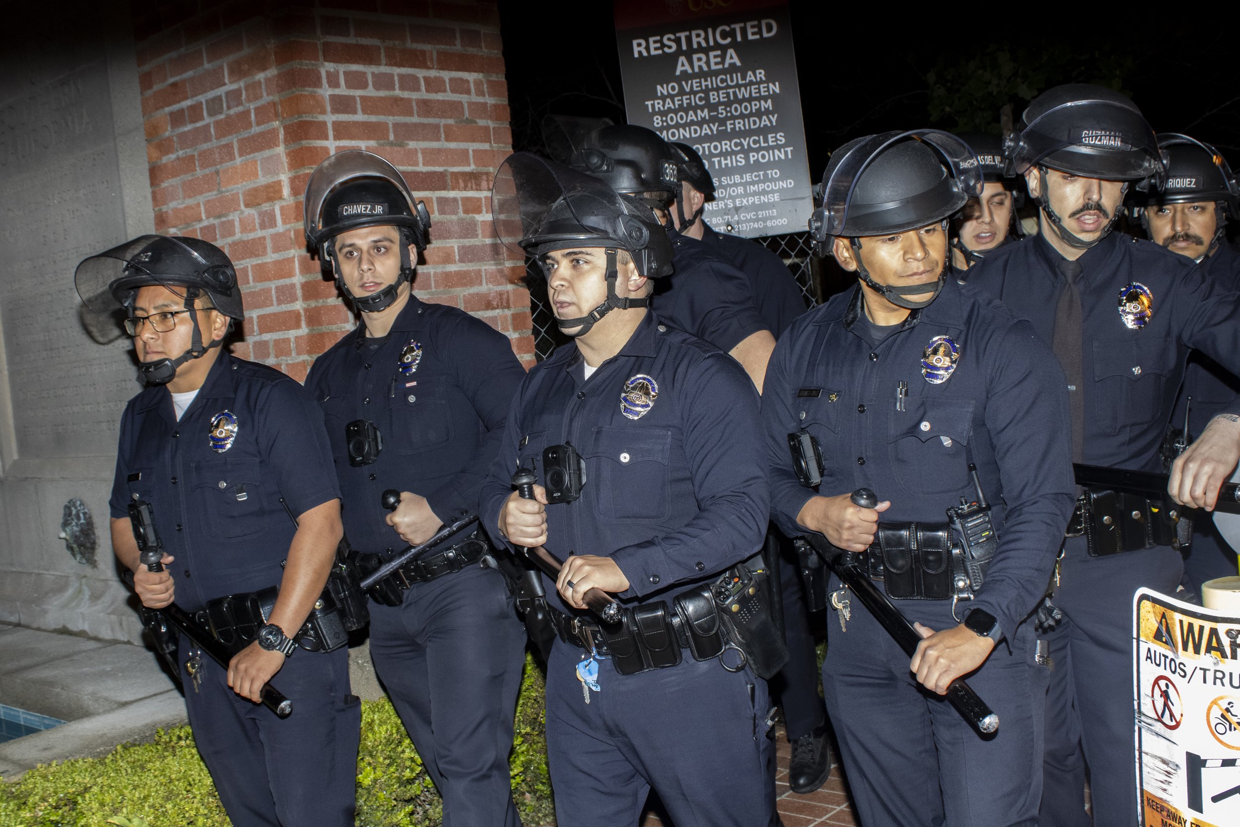  The University of Southern California Department of Security and Los Angeles Police Department officers walk their line down Trousdale Parkway moving protesters towards the exit on West Jefferson Blvd at The University of Southern California’s, in L